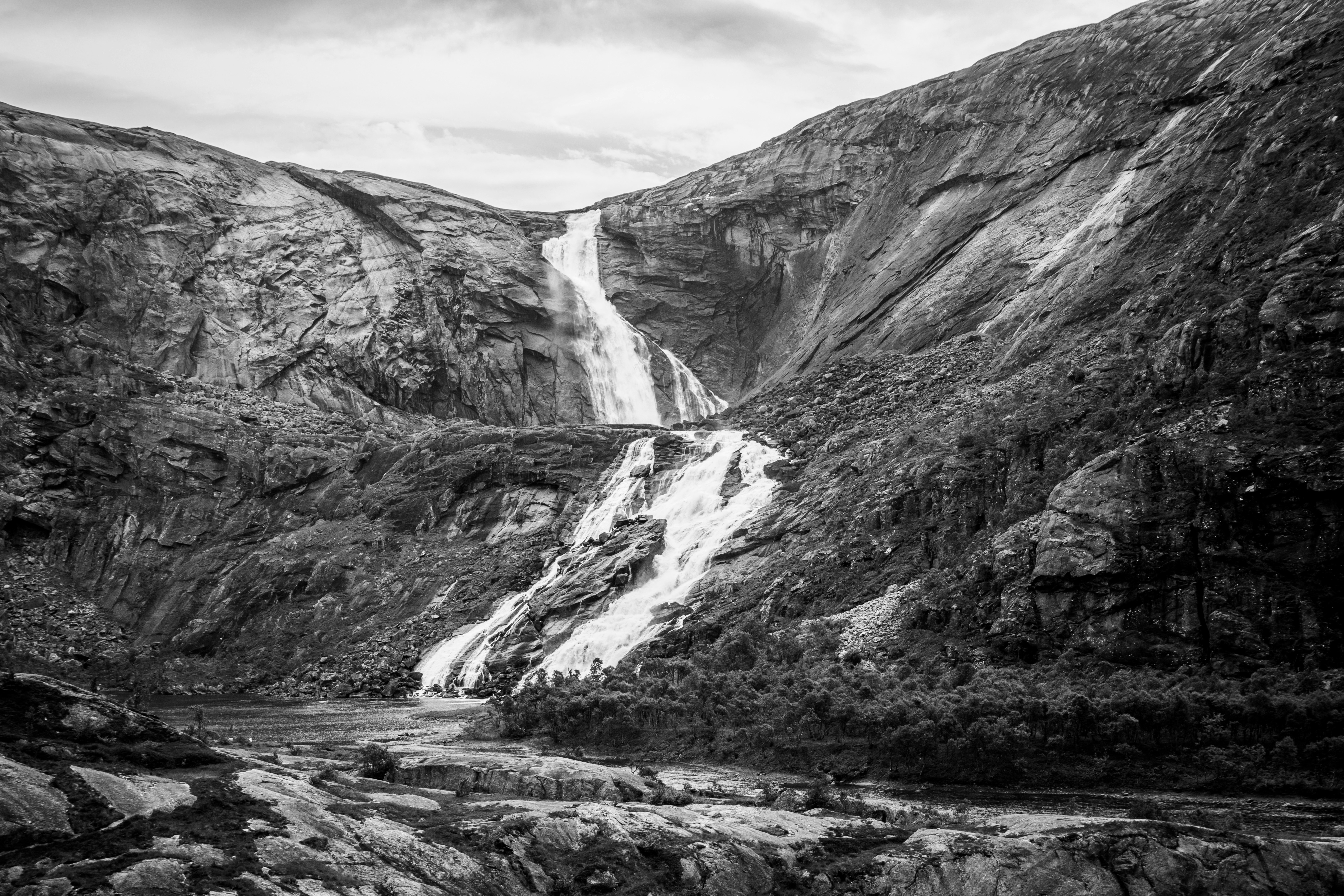A black and white photo of a waterfall