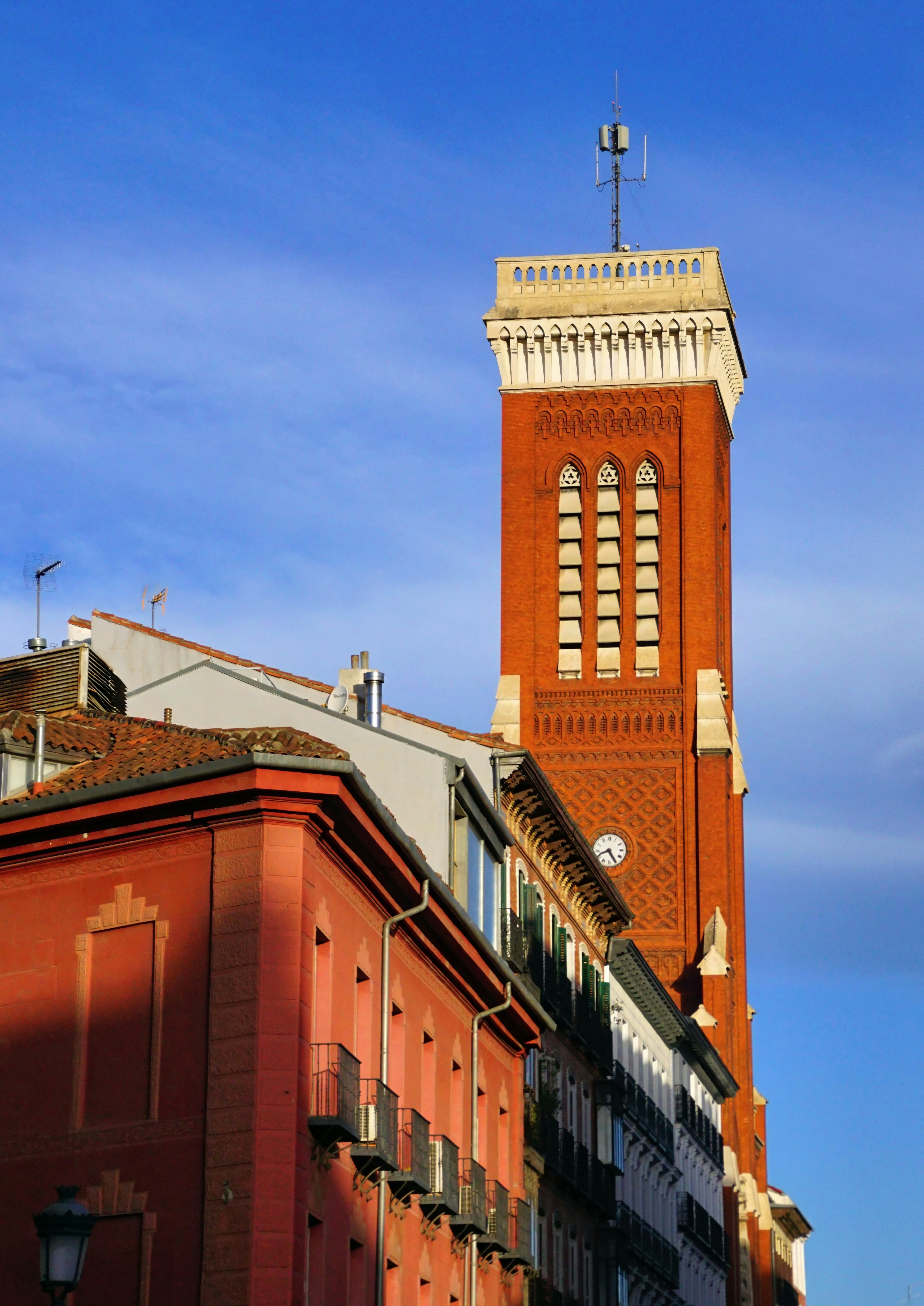 A tall brick clock tower towering over a city