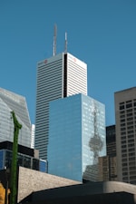 A city skyline with tall buildings and a blue sky