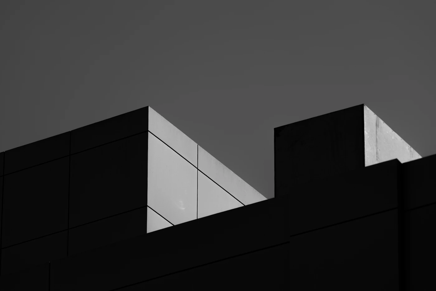 High-contrast black and white study of an angular building