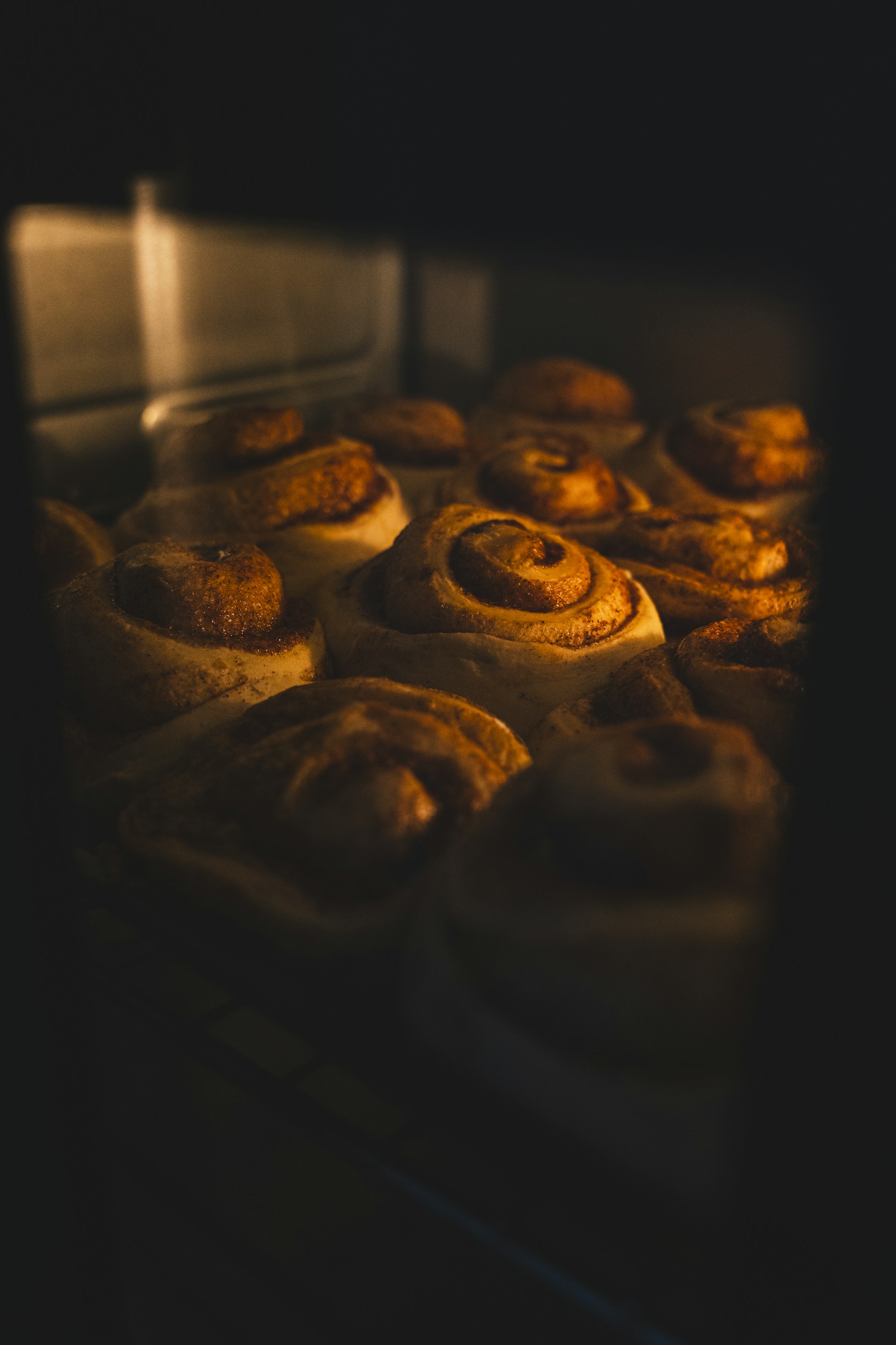 A close up of a bunch of doughnuts baking in an oven