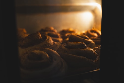 A close up of a bunch of doughnuts baking in an oven