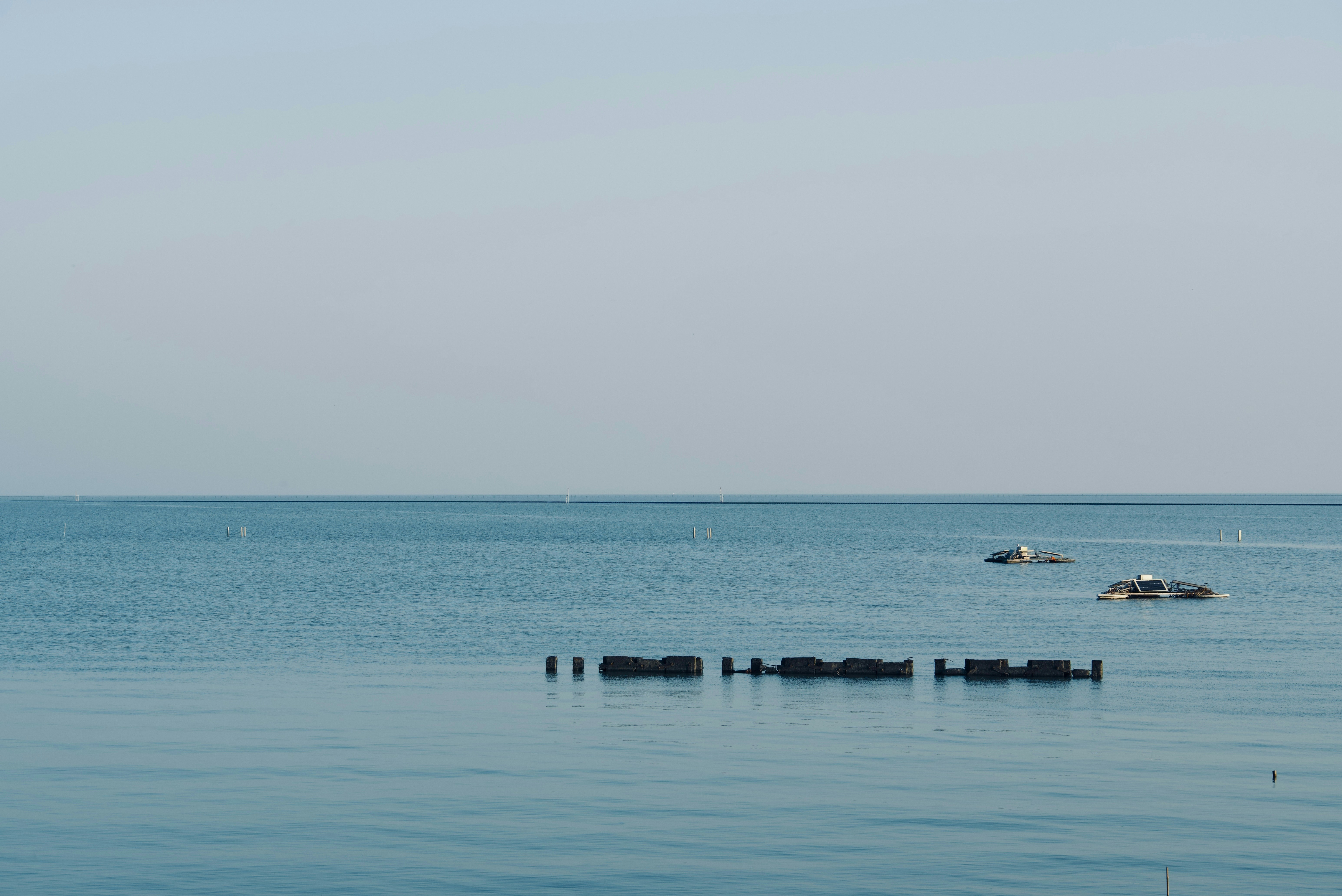 A body of water with boats in the distance