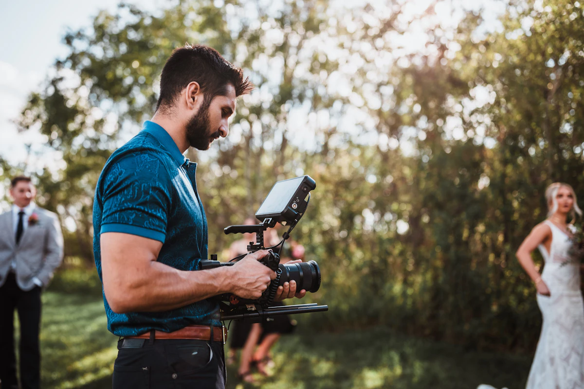 A man standing next to a woman holding a camera