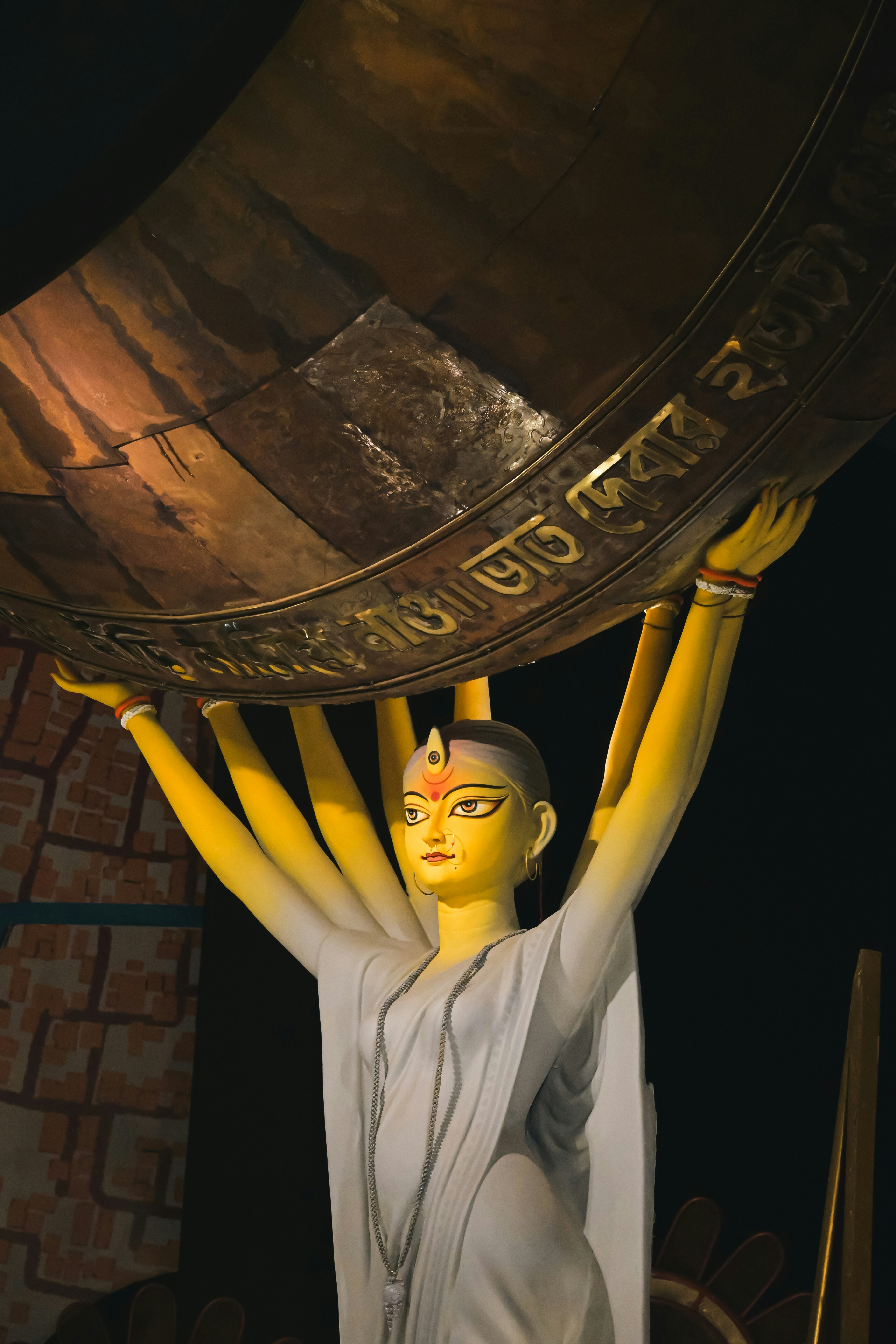 A statue of a woman holding a large golden object