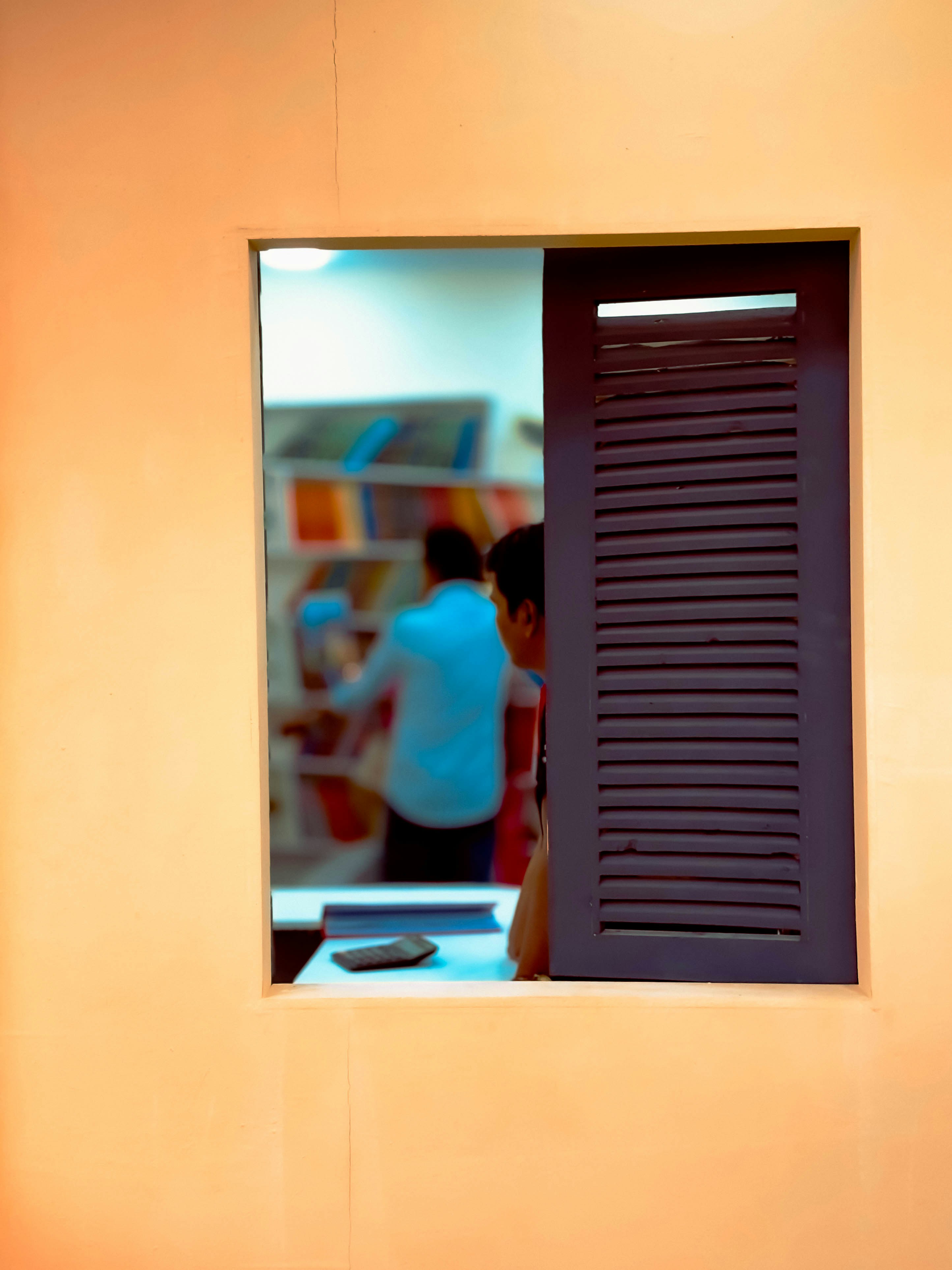 A person standing in front of a window
