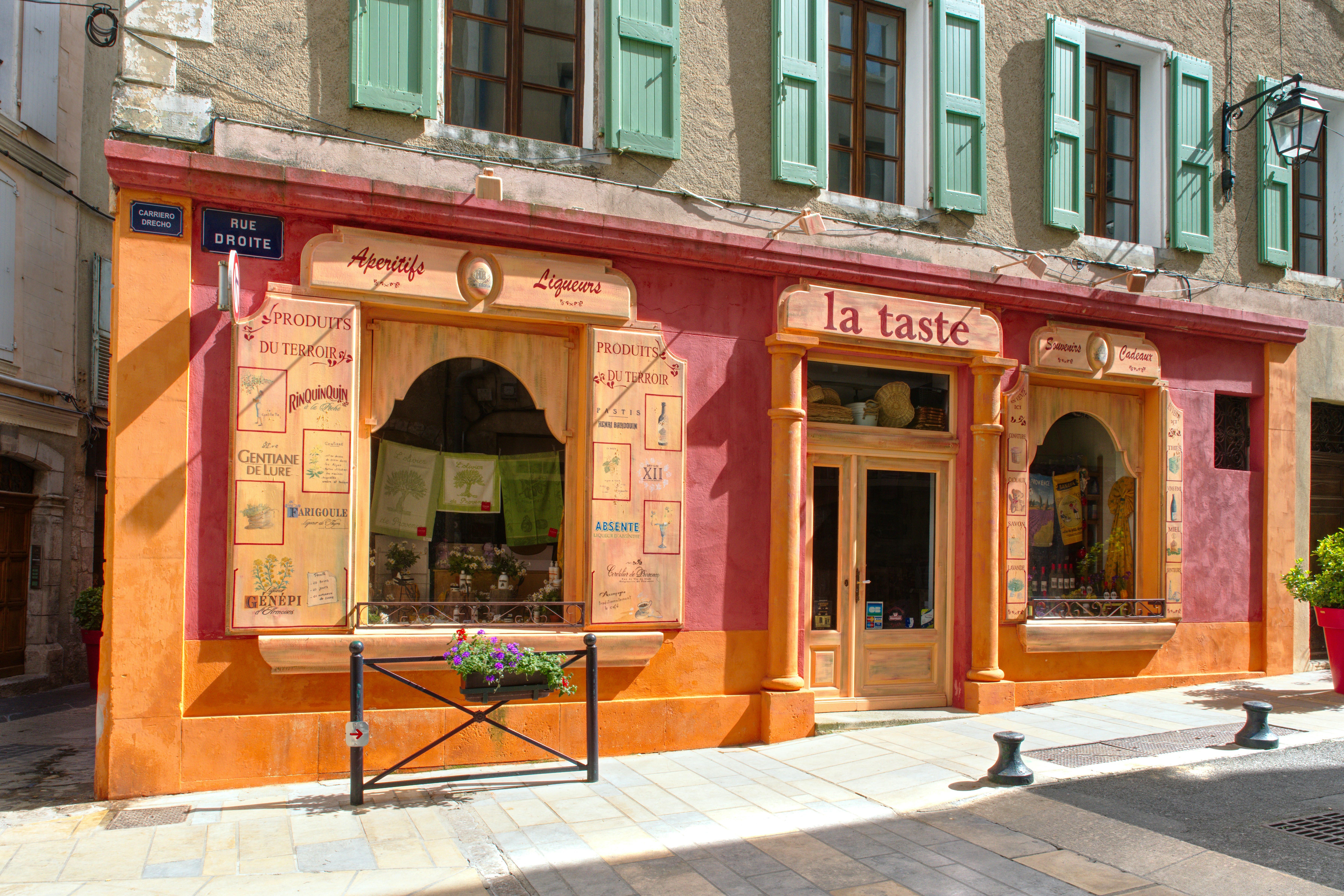 A building with green shutters on the front of it