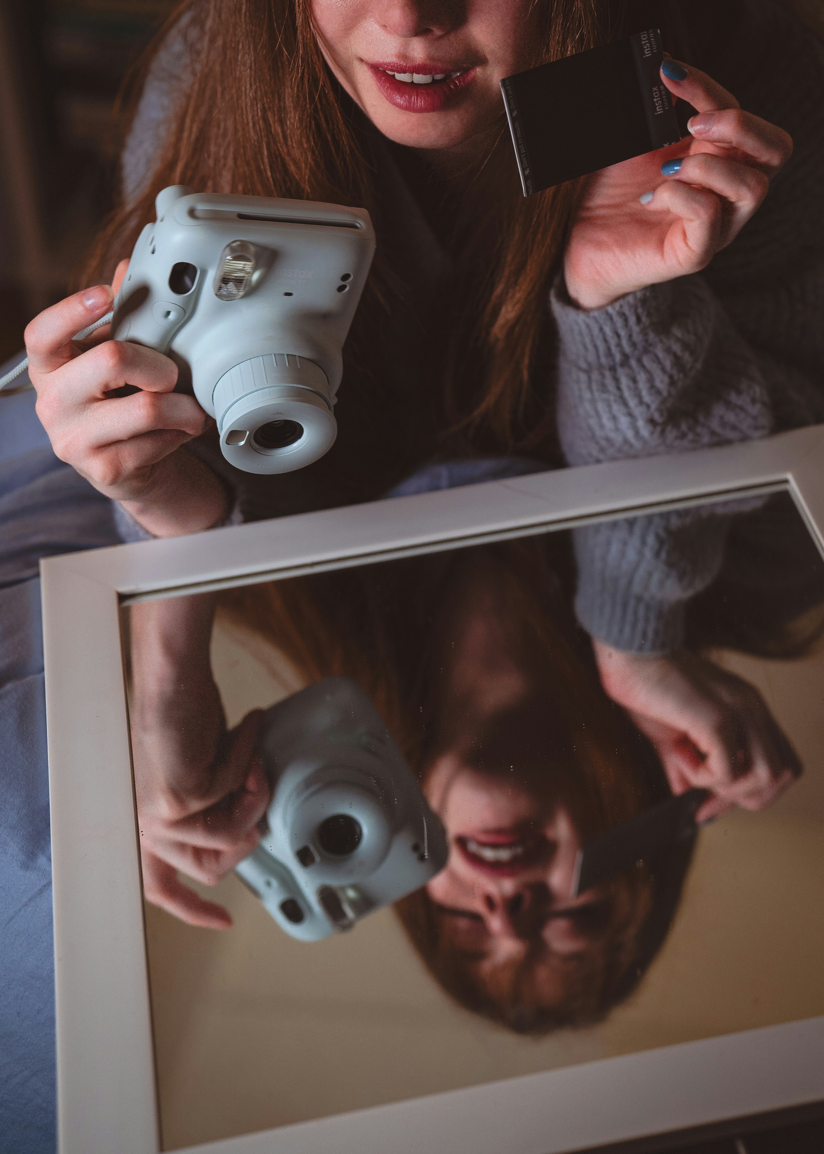 A woman taking a picture of herself with a camera