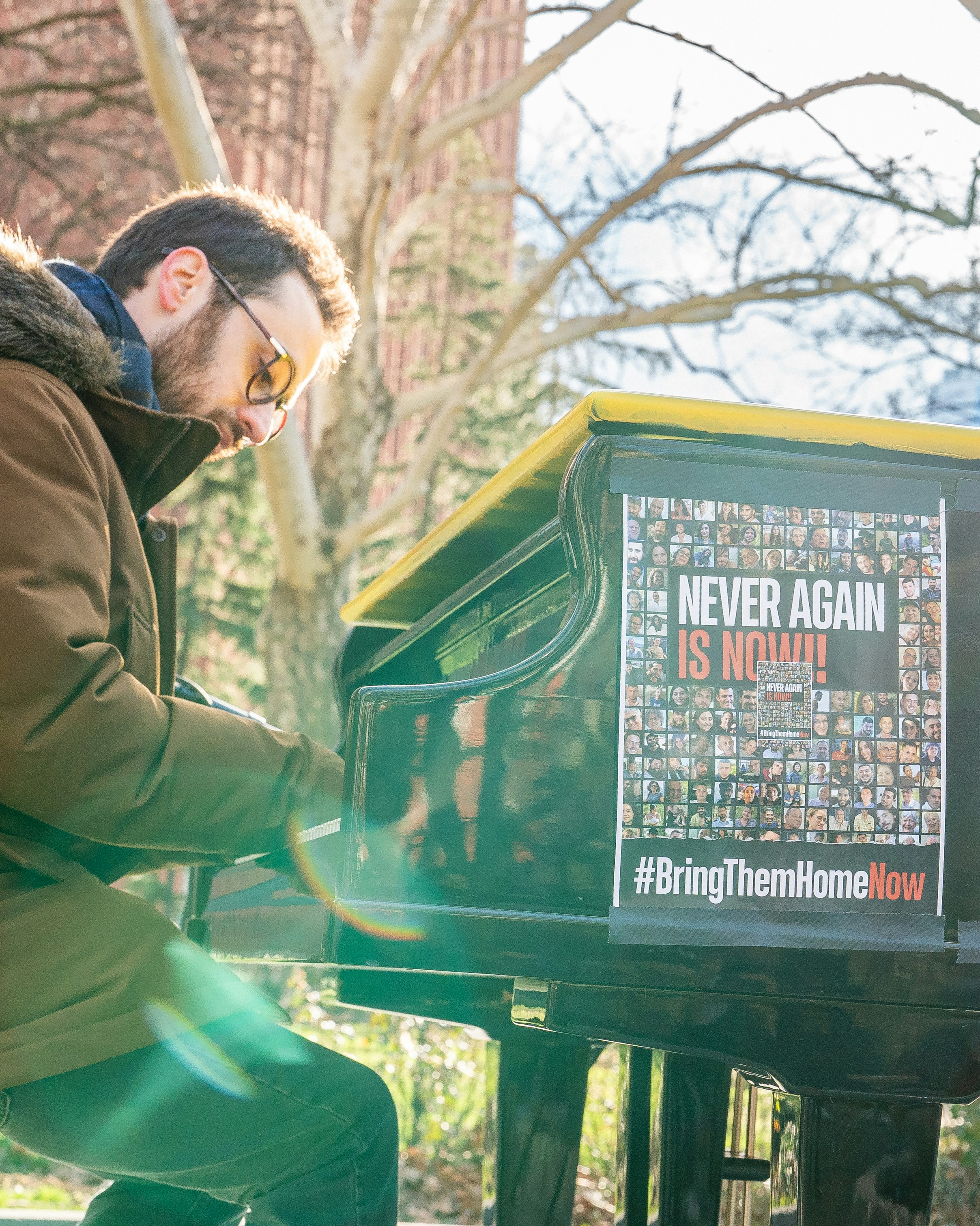 A man playing a piano in a park