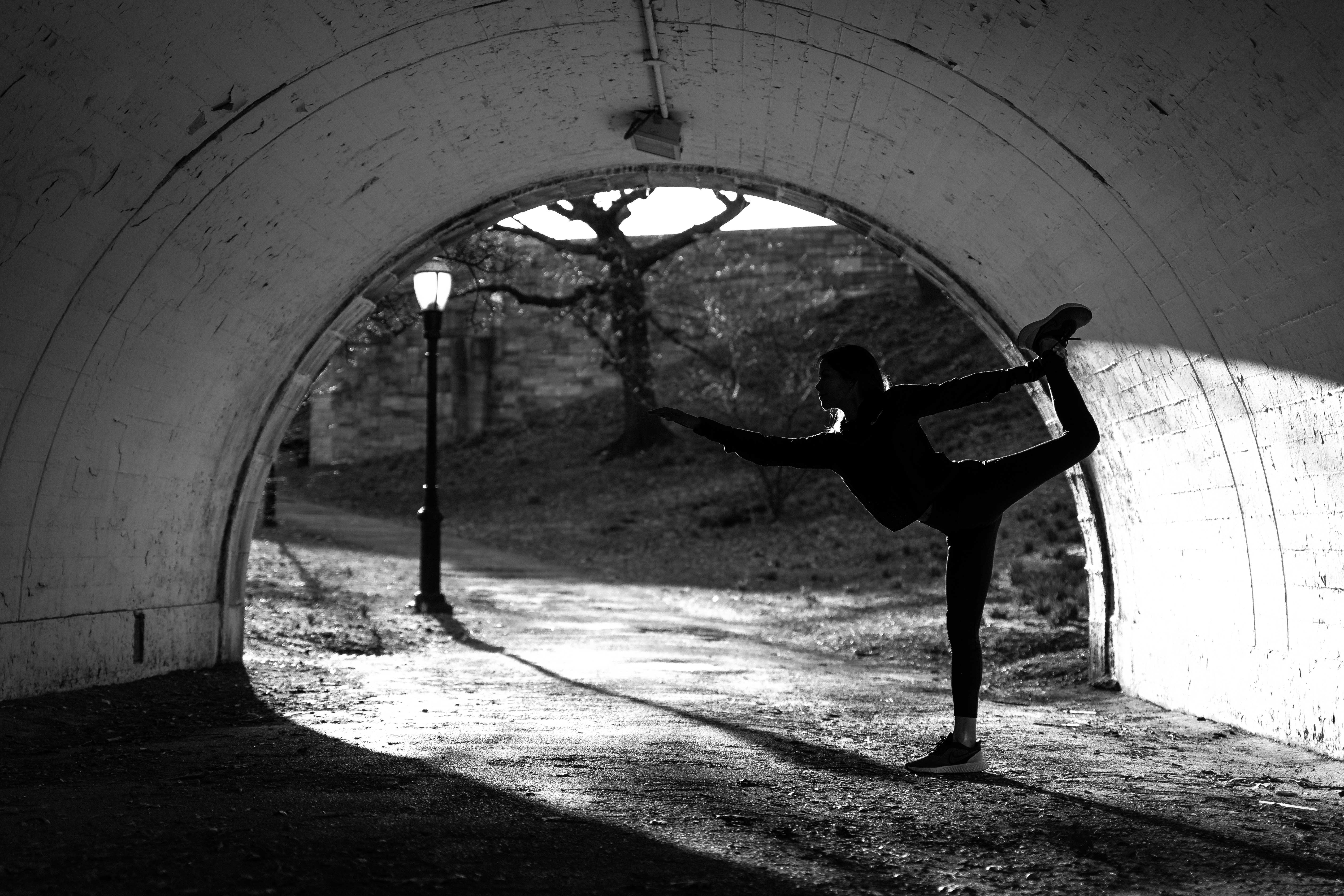 A person doing a yoga pose in a tunnel
