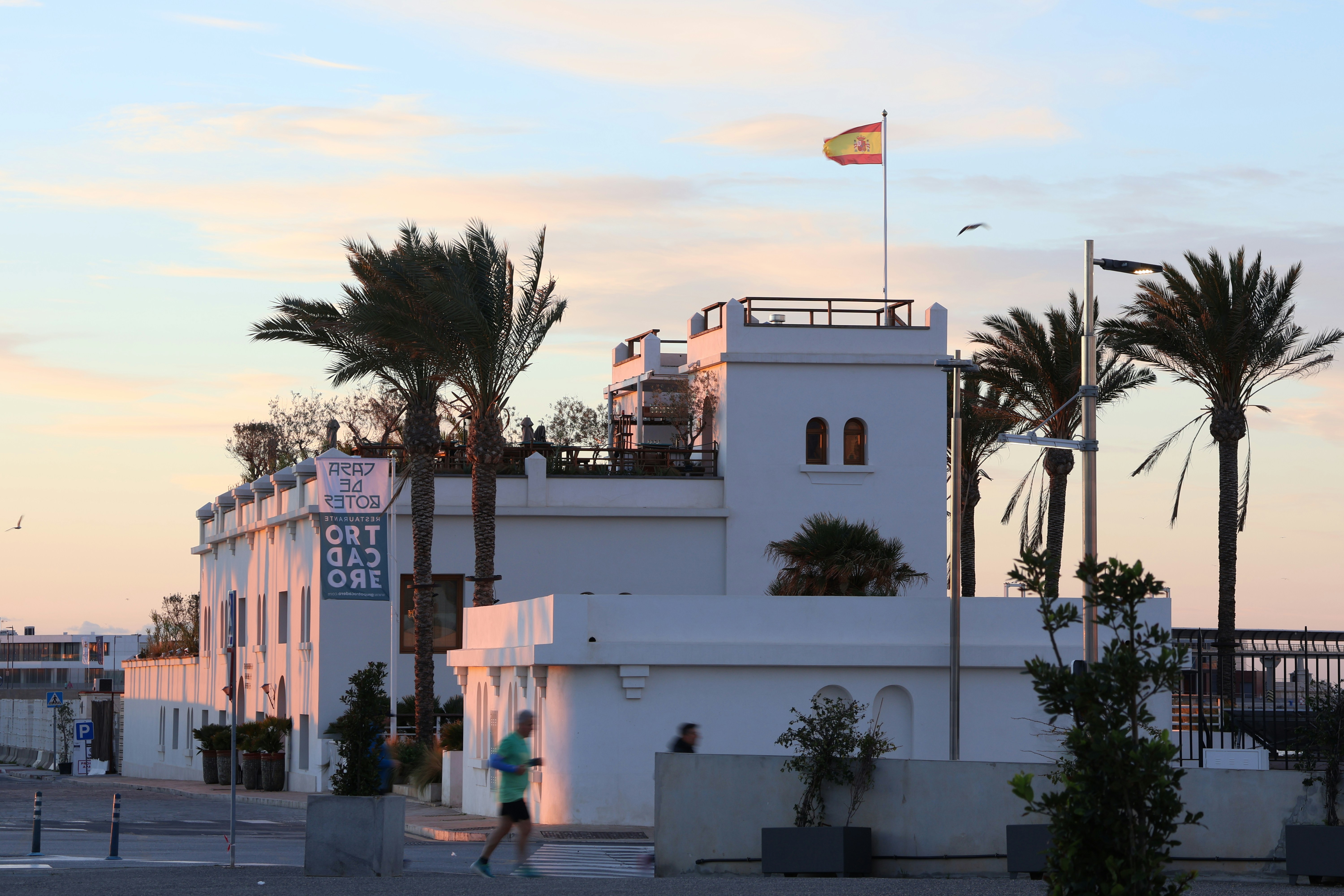 A white building with a flag on top of it