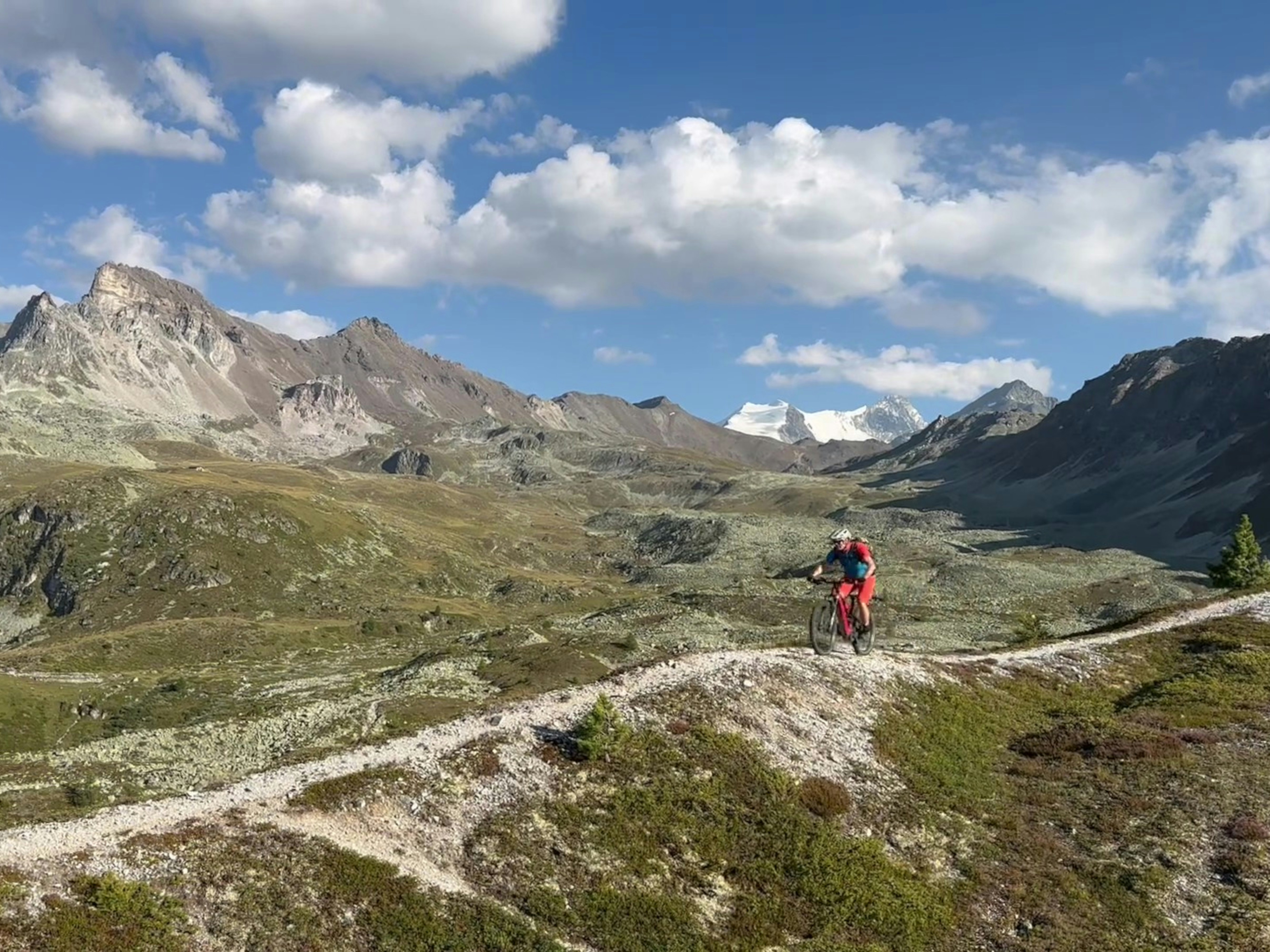 A man riding a bike down a dirt road