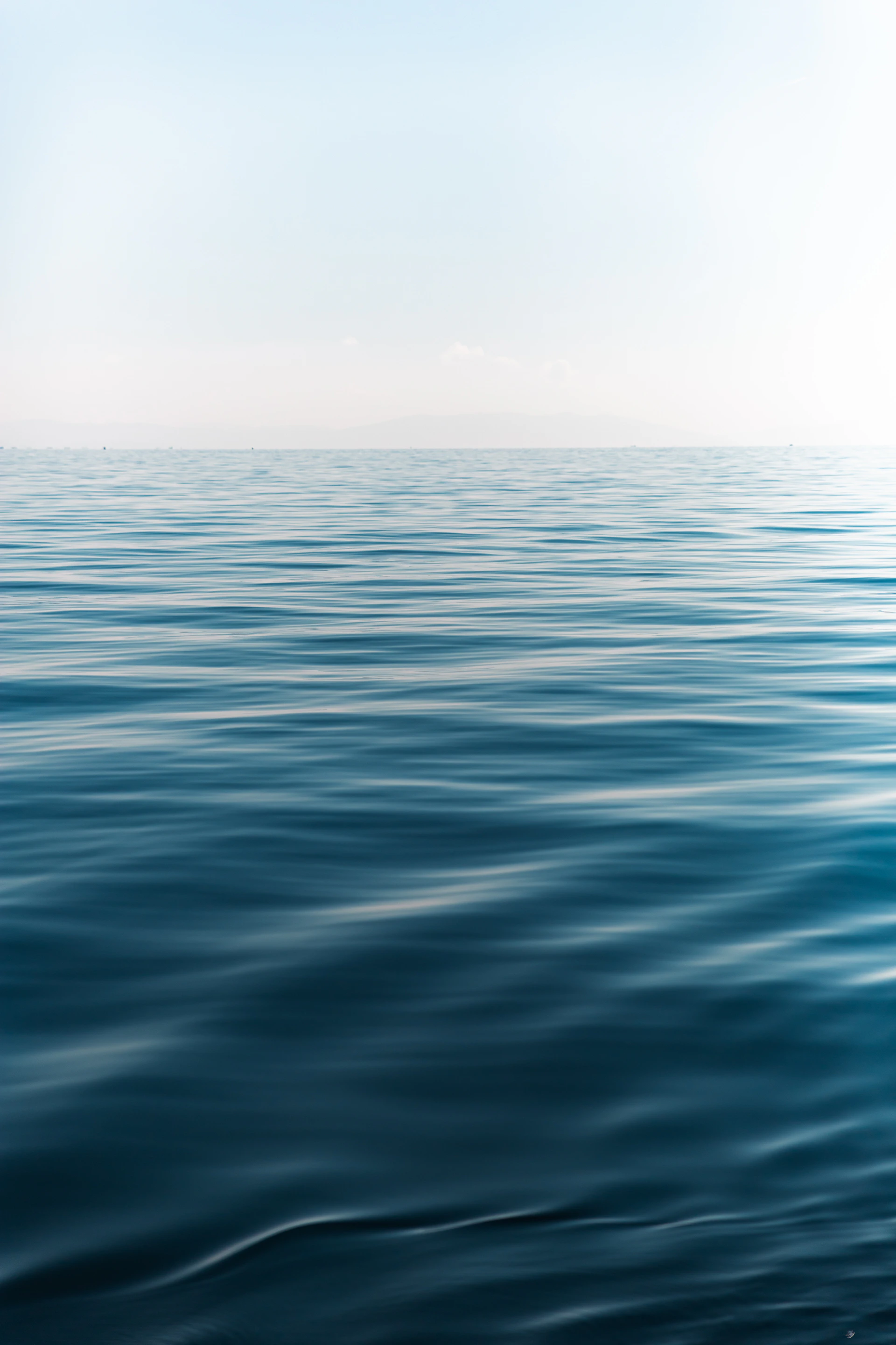 A large body of water with a sky in the background