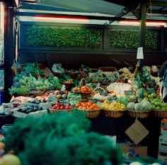 A man standing in front of a display of fruits and vegetables
