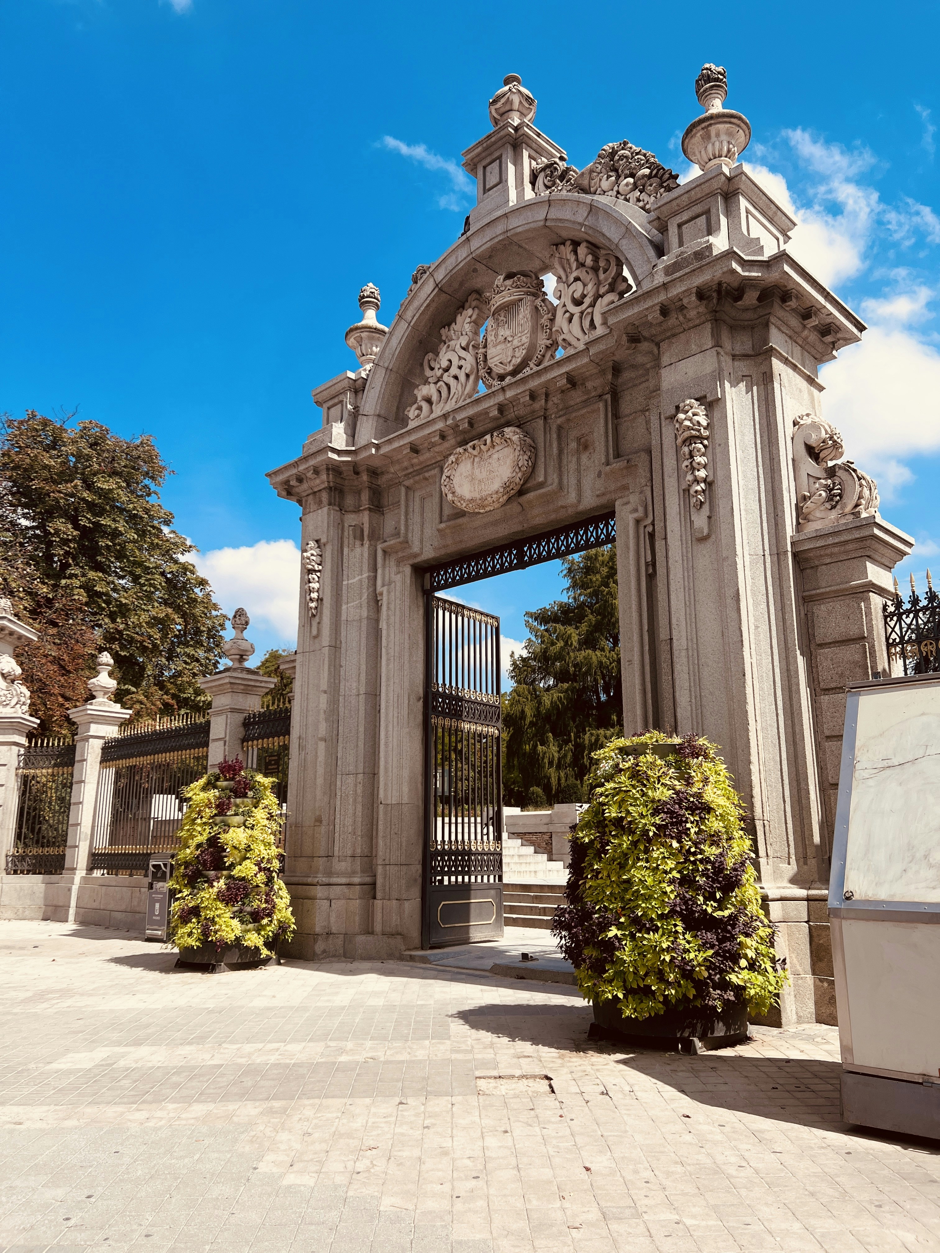 A large gate with a clock on the top of it photo – Free Madrid Image on ...