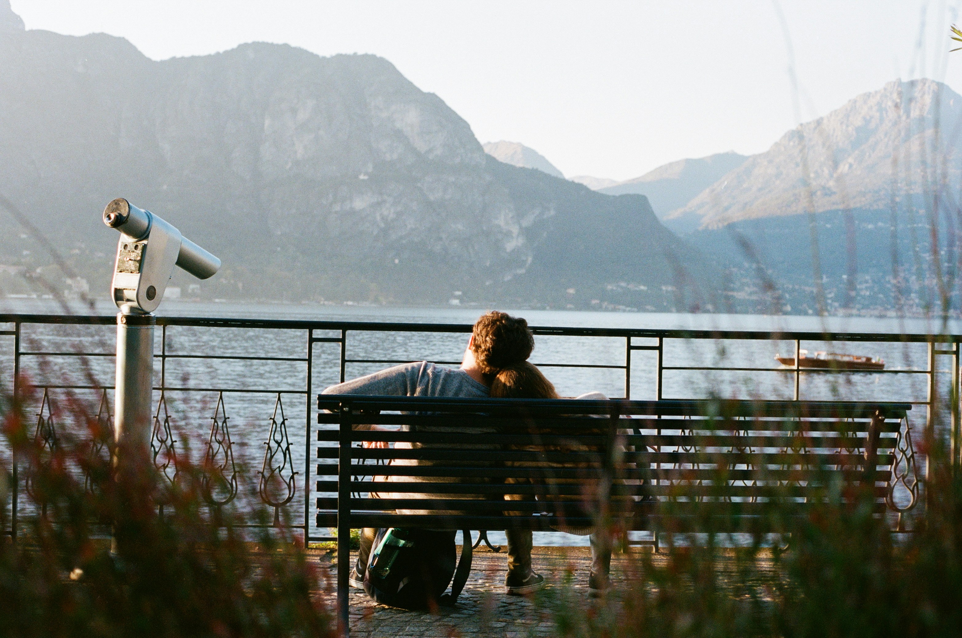 A person sitting on a bench near a body of water