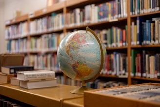 A globe sitting on a table in a library