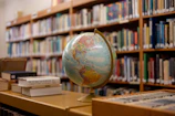 A globe sitting on a table in a library