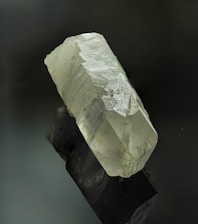 A rock with a white substance on top of it