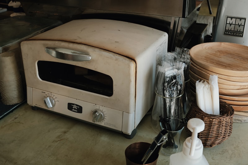 Vintage cream countertop convection oven in compact café kitchen setting
