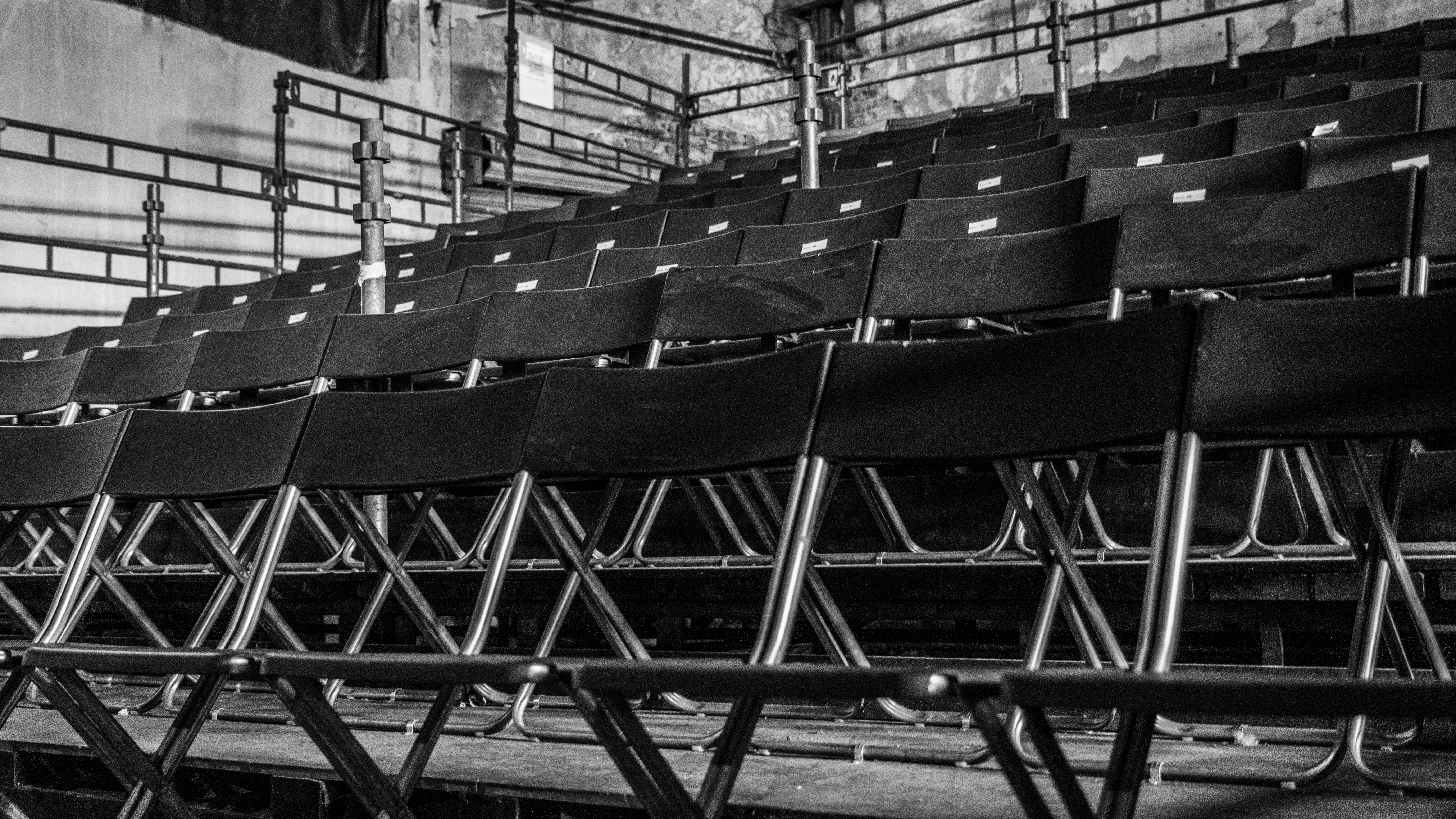 A row of empty chairs sitting next to each other