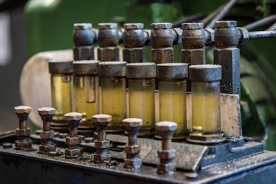 A row of oil bottles sitting on top of a machine