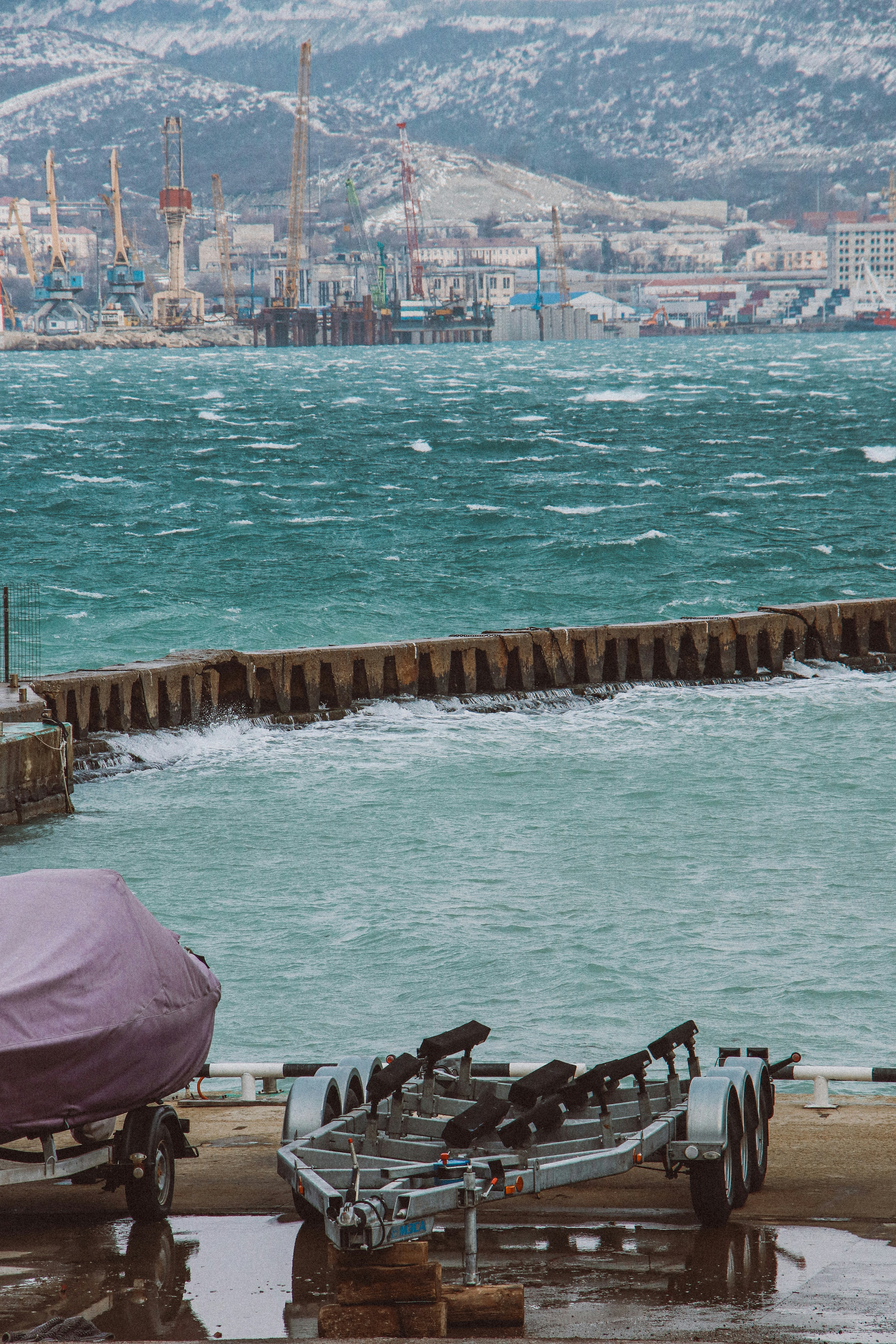 A boat sitting on top of a pier next to the ocean