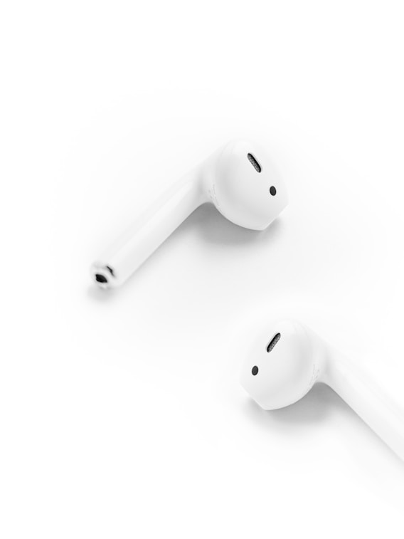A pair of ear buds sitting next to each other