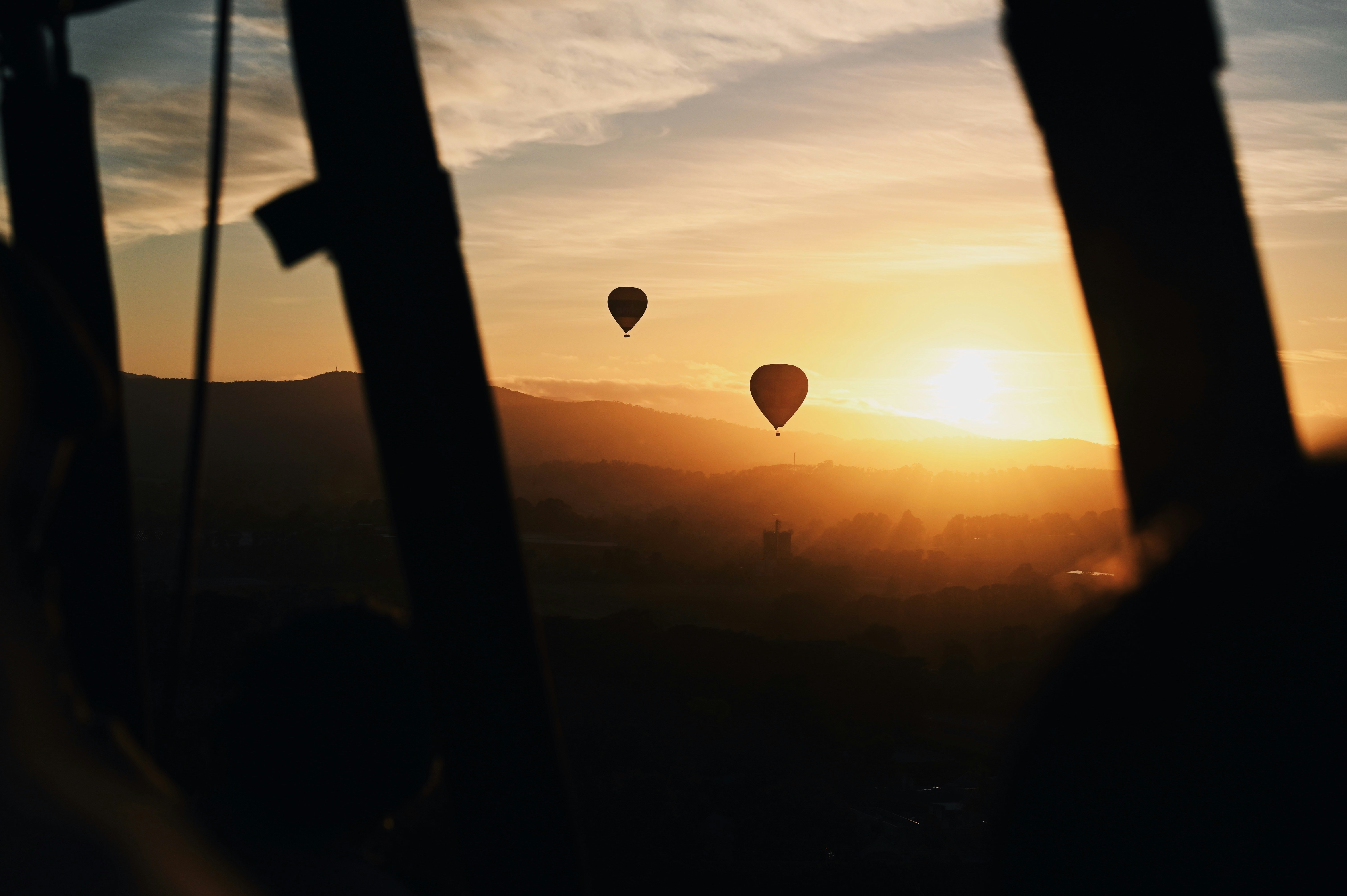 A group of hot air balloons flying in the sky