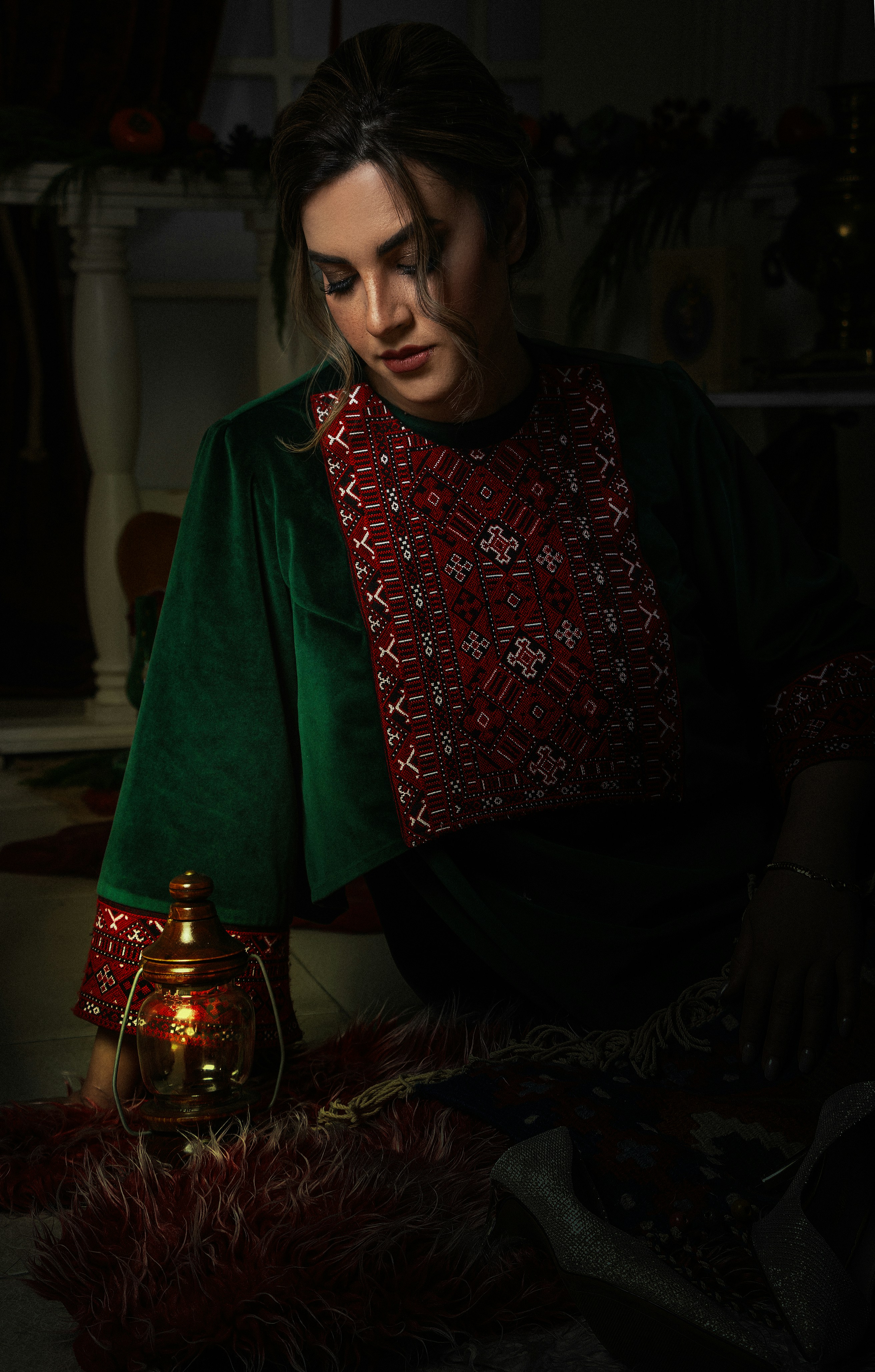 A woman in a dark room with a lamp