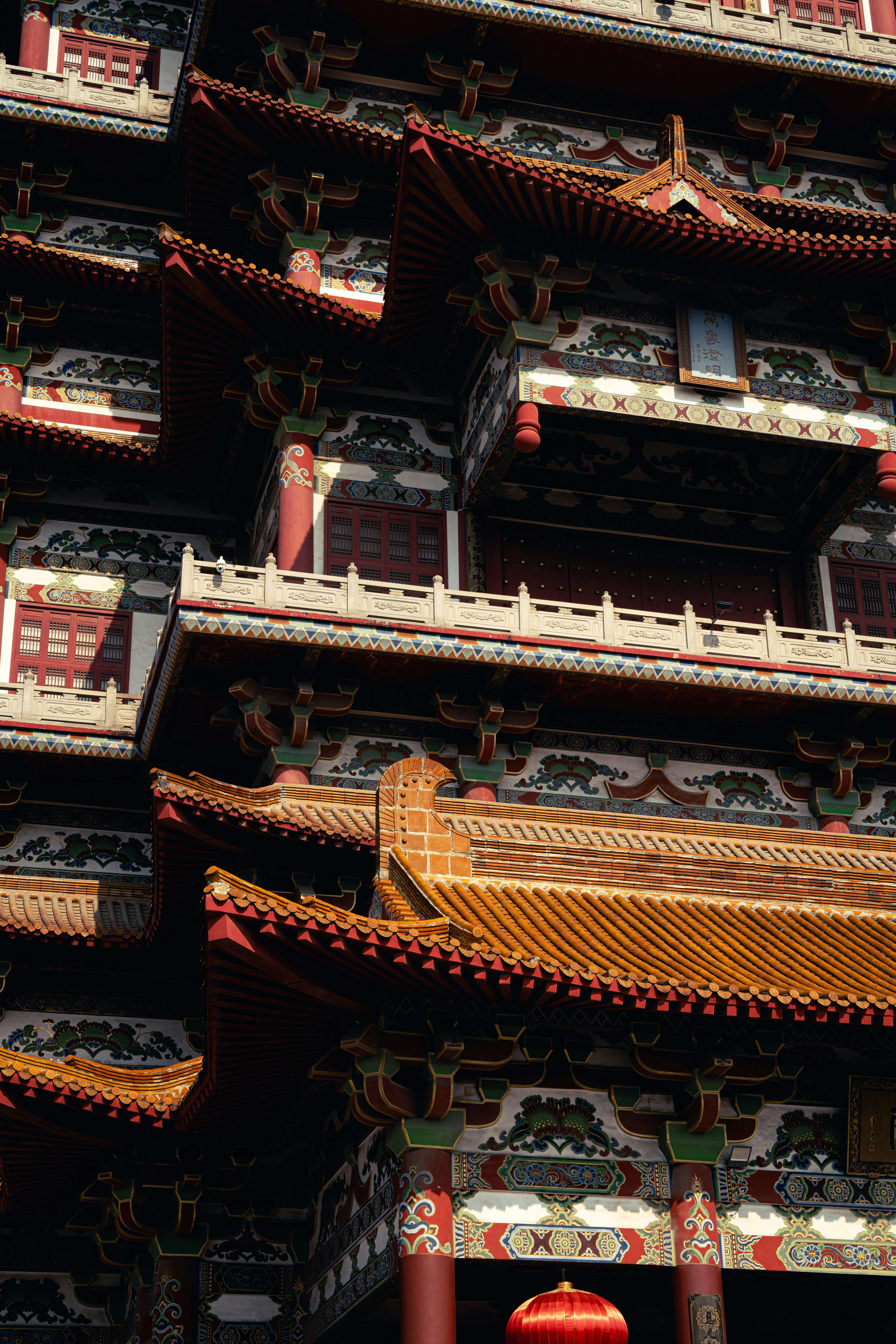 A tall building with red and yellow decorations on it