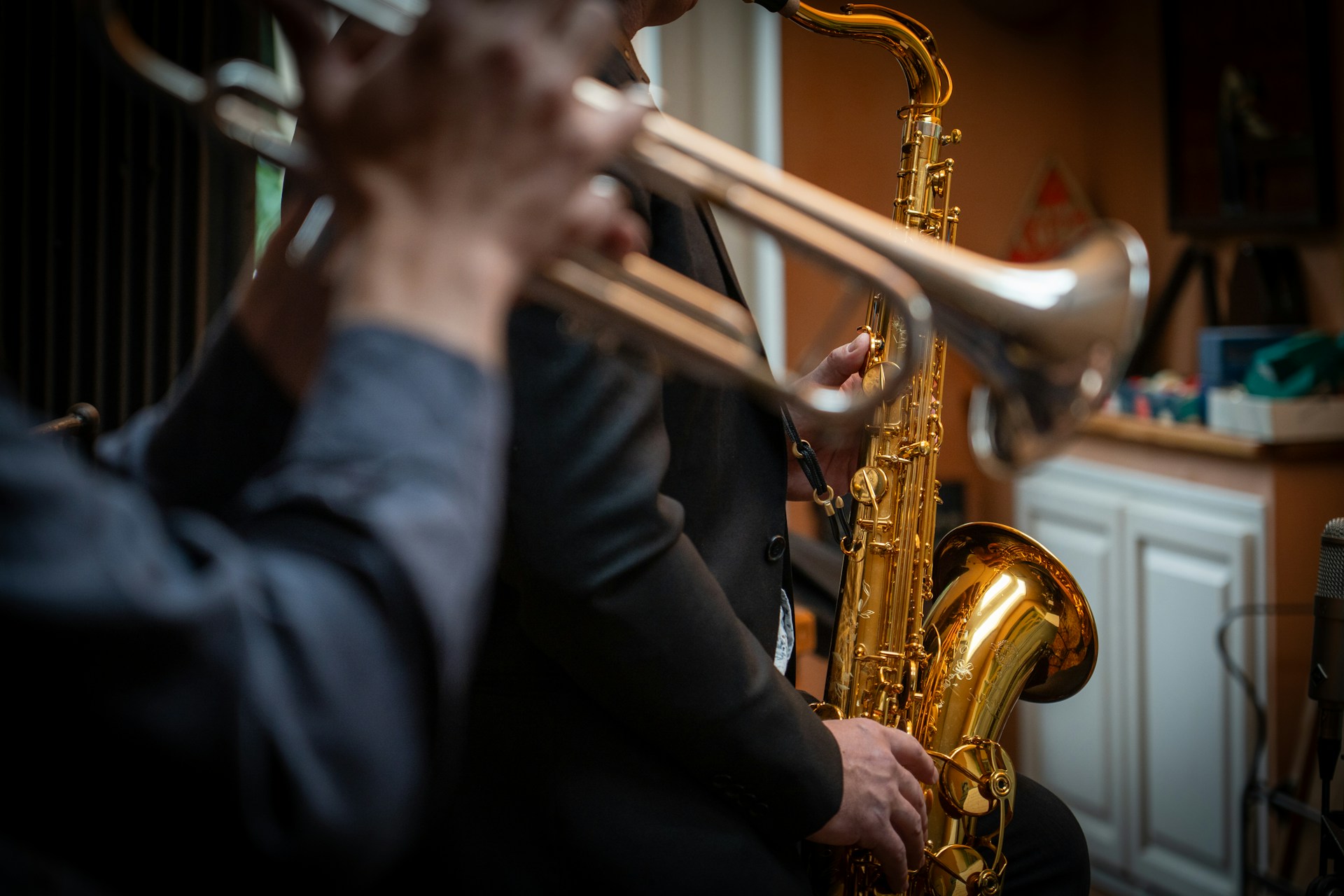 A man playing a trumpet in a room