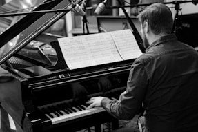 A man playing a piano in a recording studio
