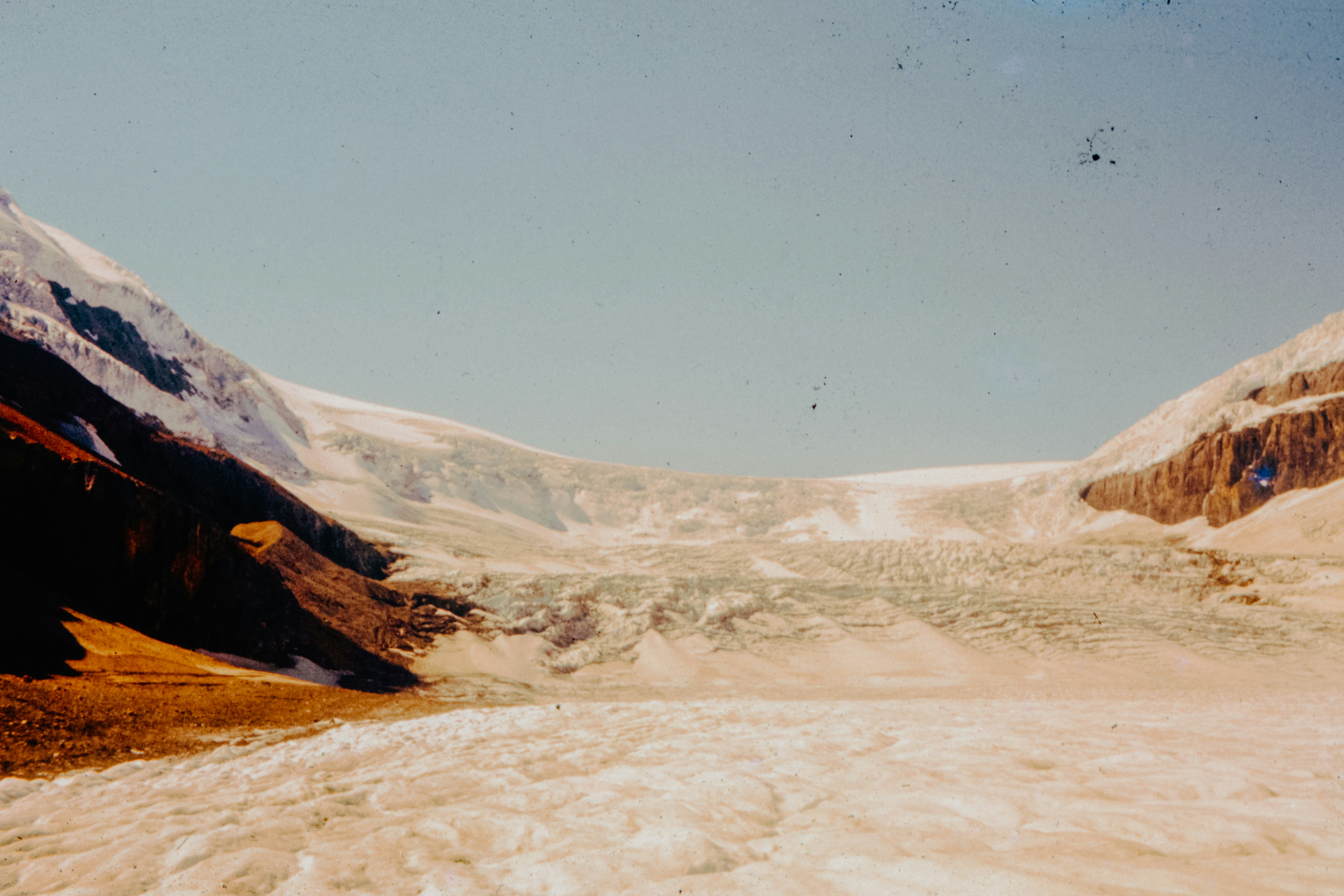 A view of a snow covered mountain from a vehicle