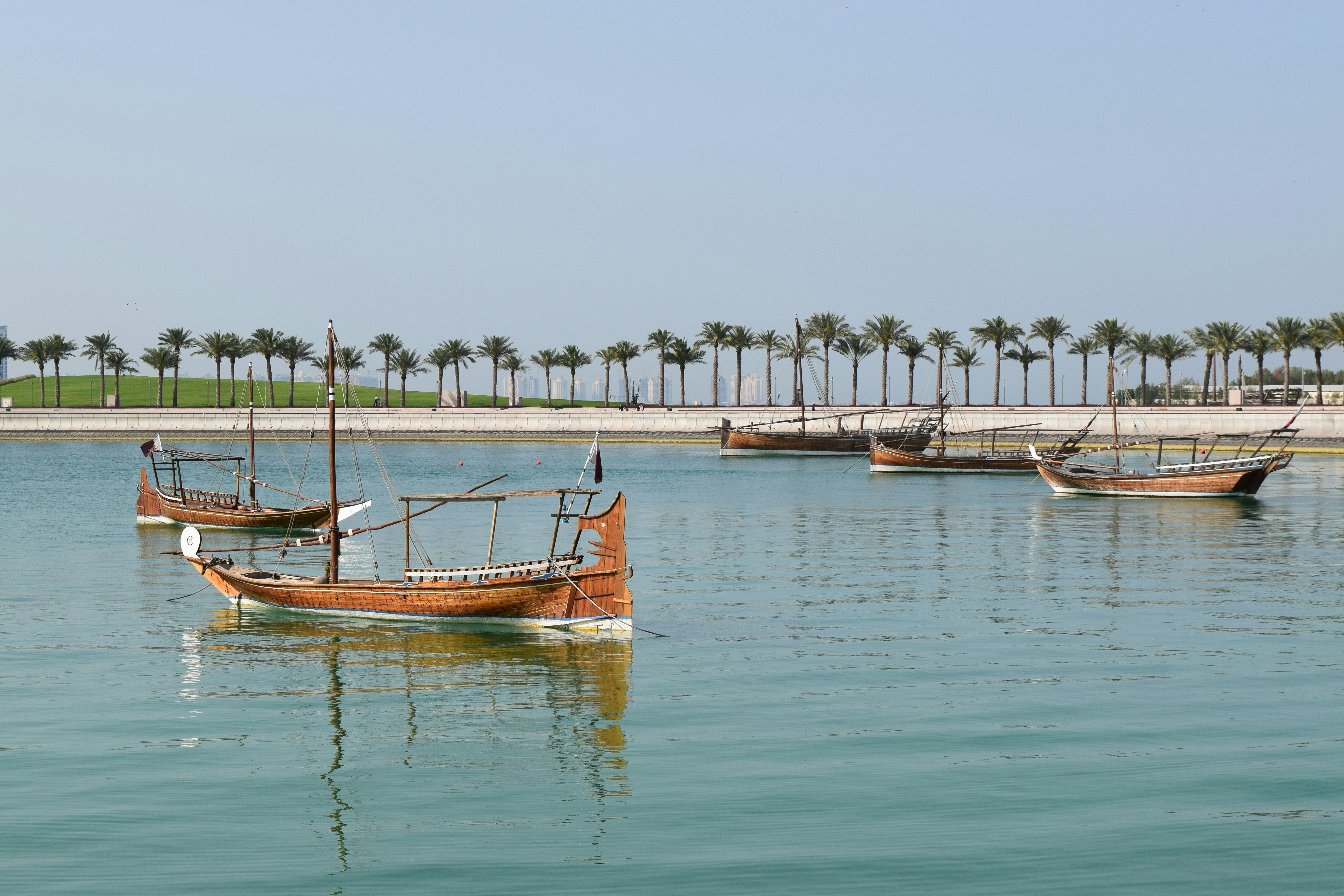 A group of boats floating on top of a body of water
