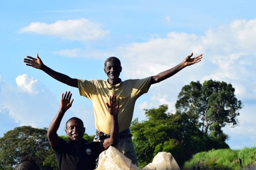 A man standing on top of a white horse