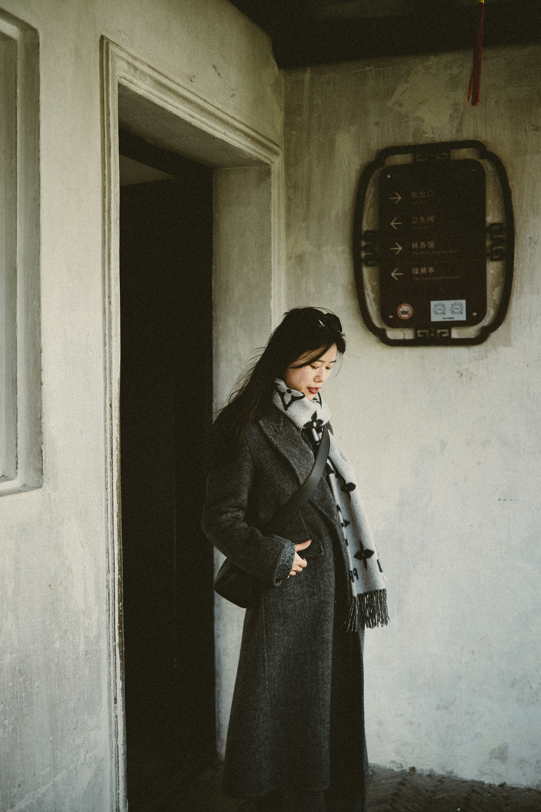A woman standing in a doorway of a building