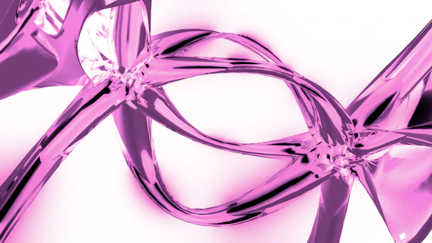 A close up of a pink ribbon on a white background