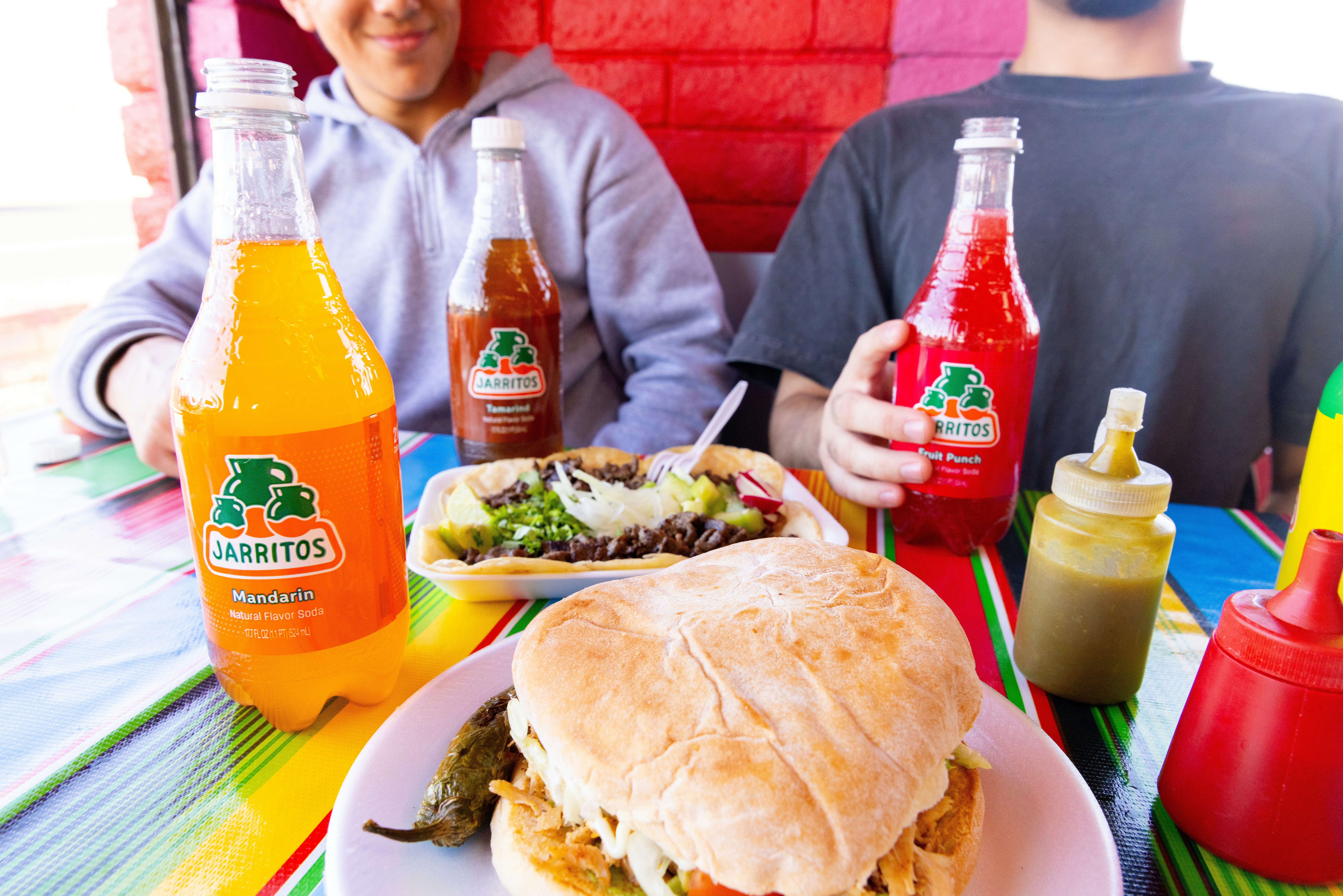 A man sitting at a table with a plate of food