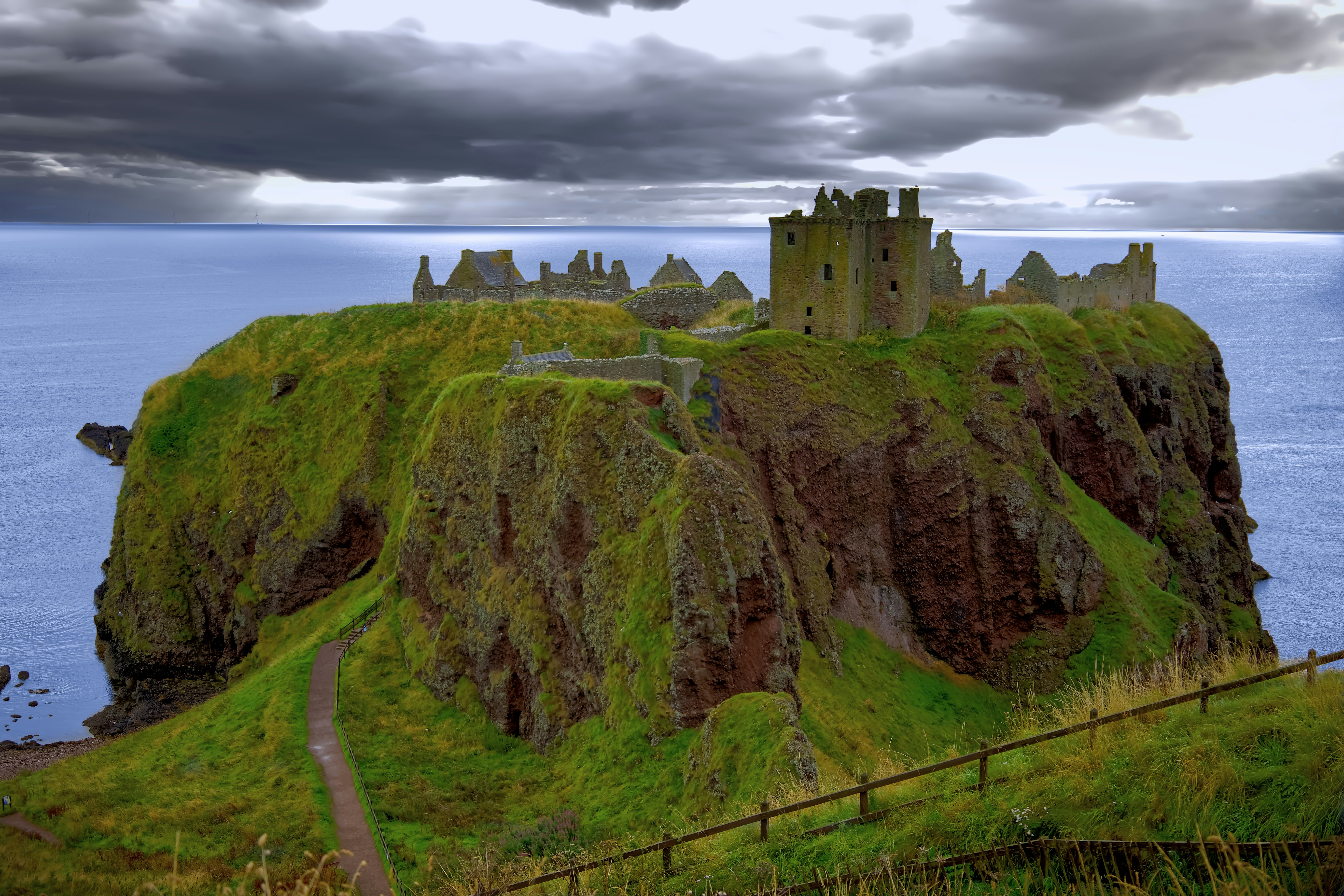 A castle sitting on top of a cliff next to the ocean