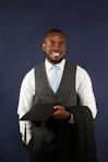 A man in a suit and tie holding a piece of paper