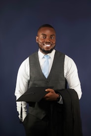 A man in a suit and tie holding a piece of paper