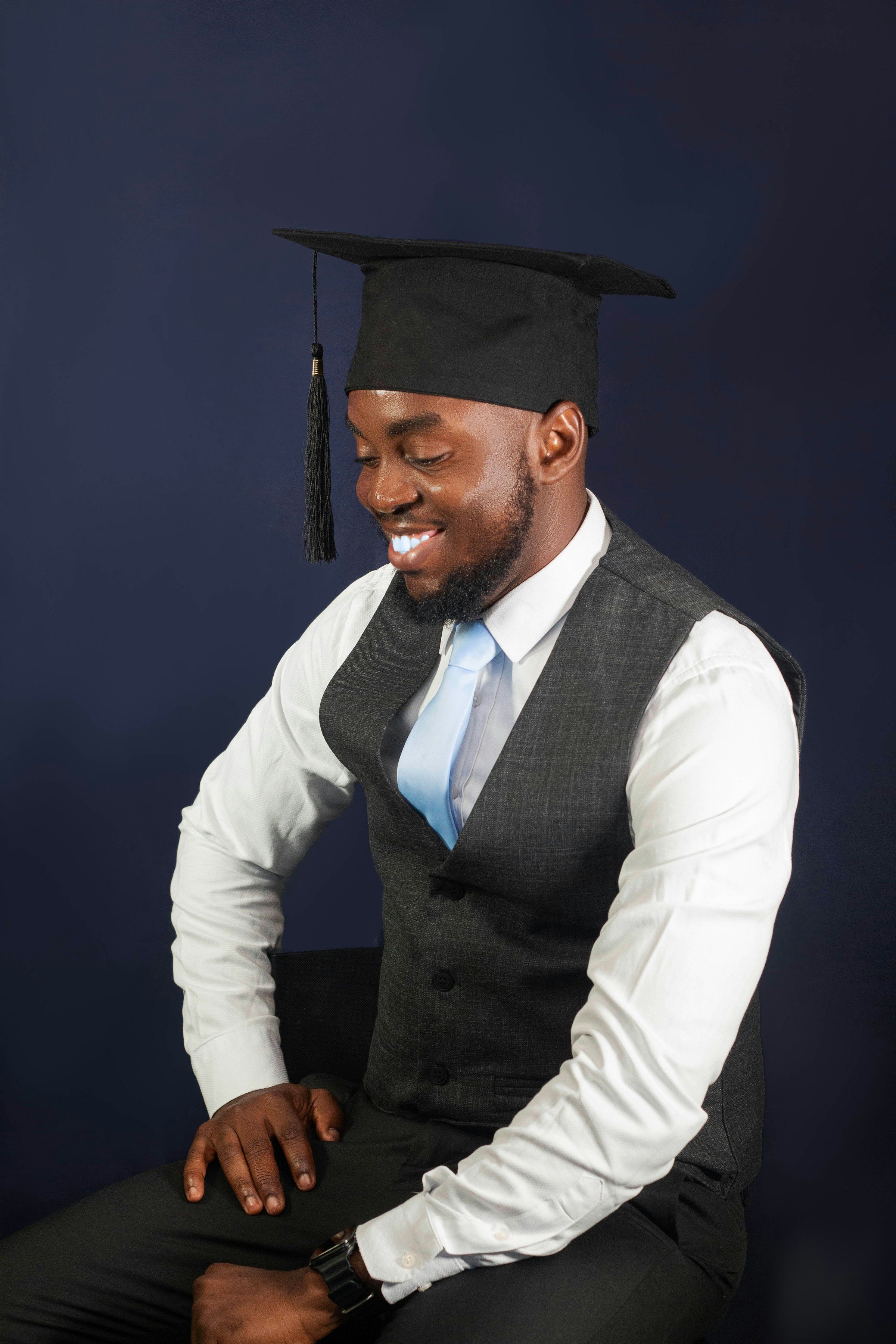 A man in a suit and tie sitting on a chair