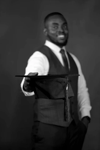 A man in a vest and tie holding a piece of paper