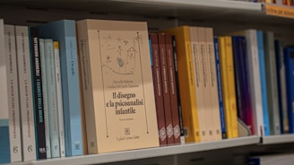 A row of books sitting on top of a book shelf