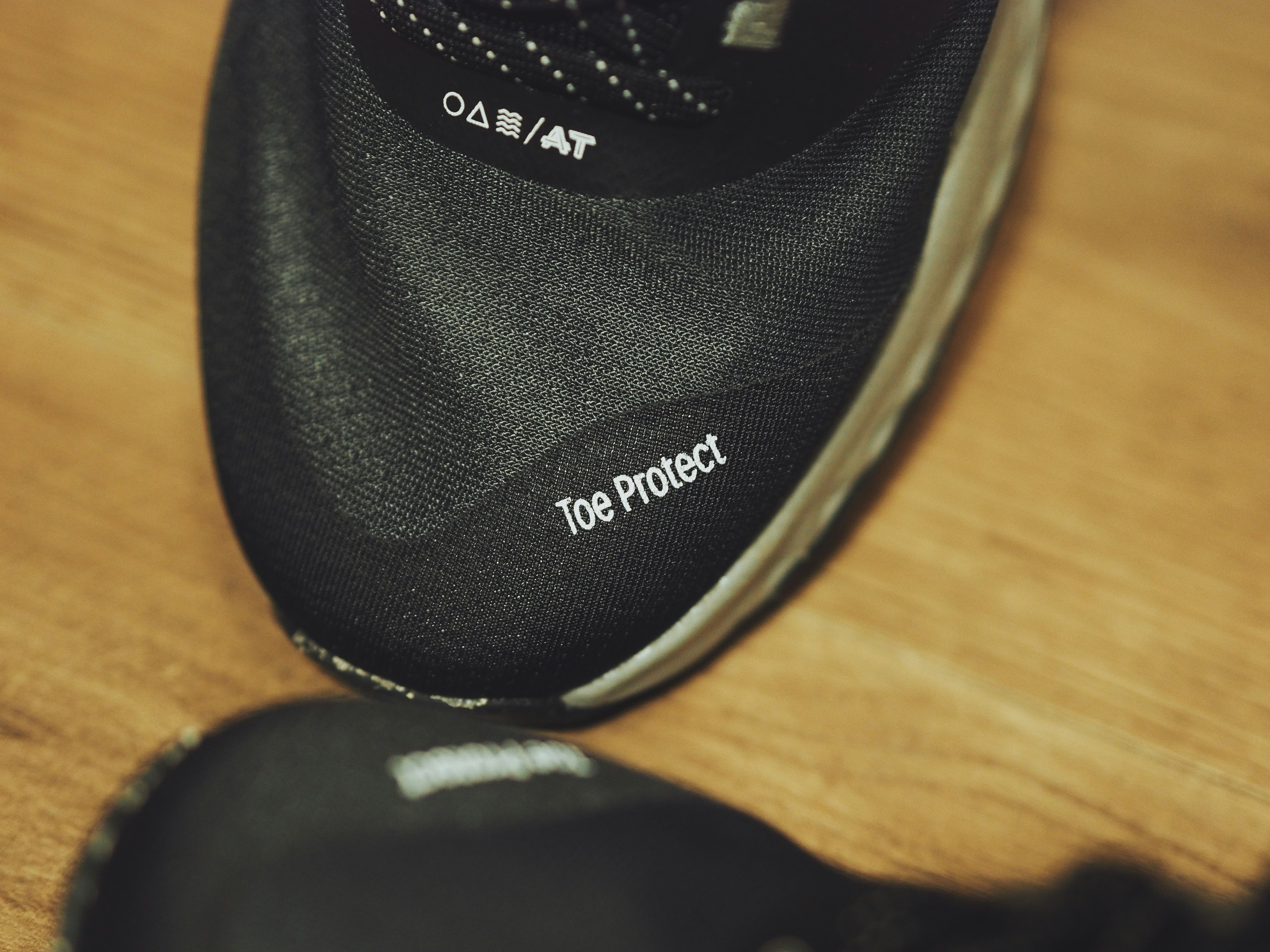 A pair of black shoes sitting on top of a wooden floor