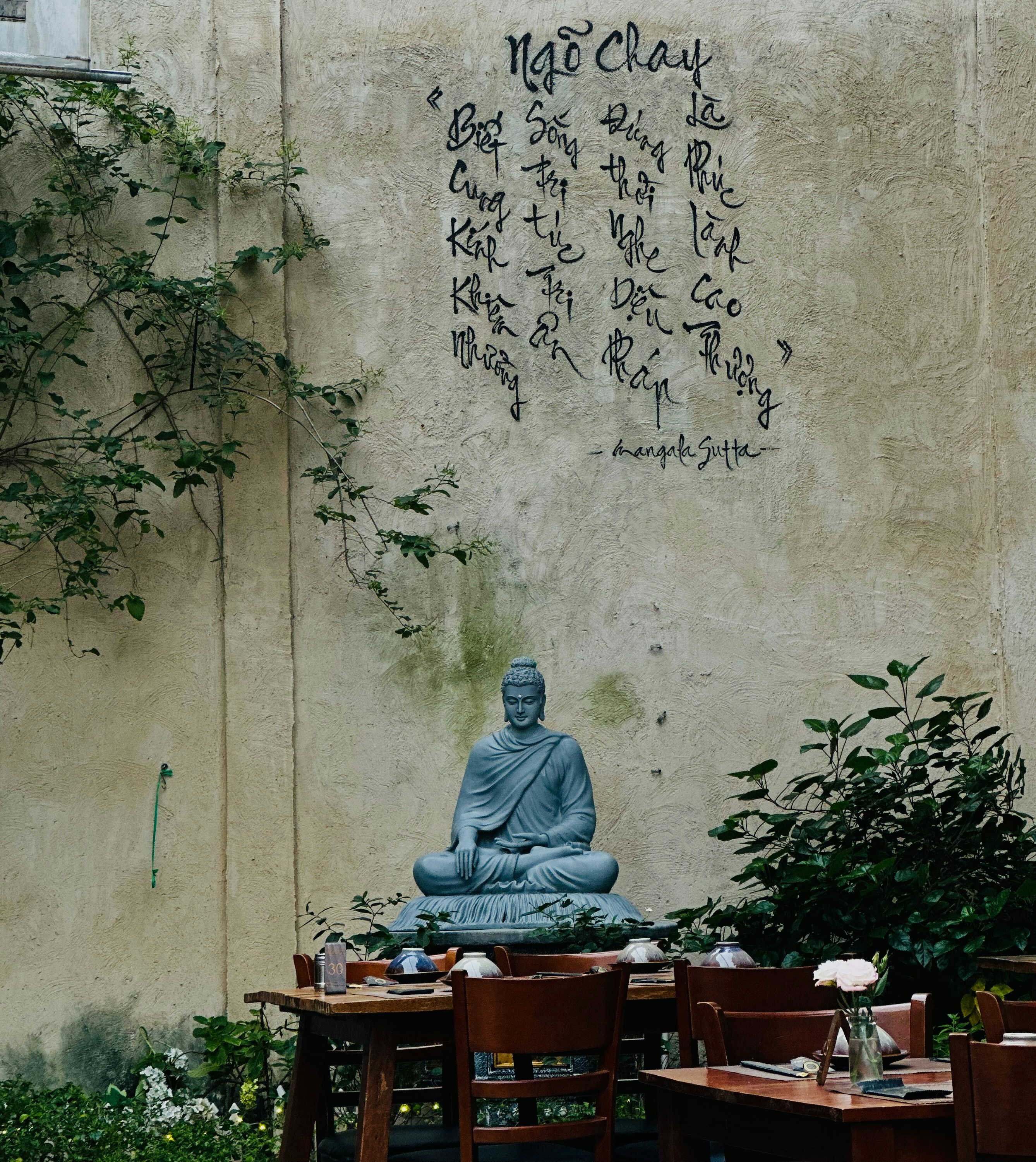 A buddha statue sitting on top of a wooden table