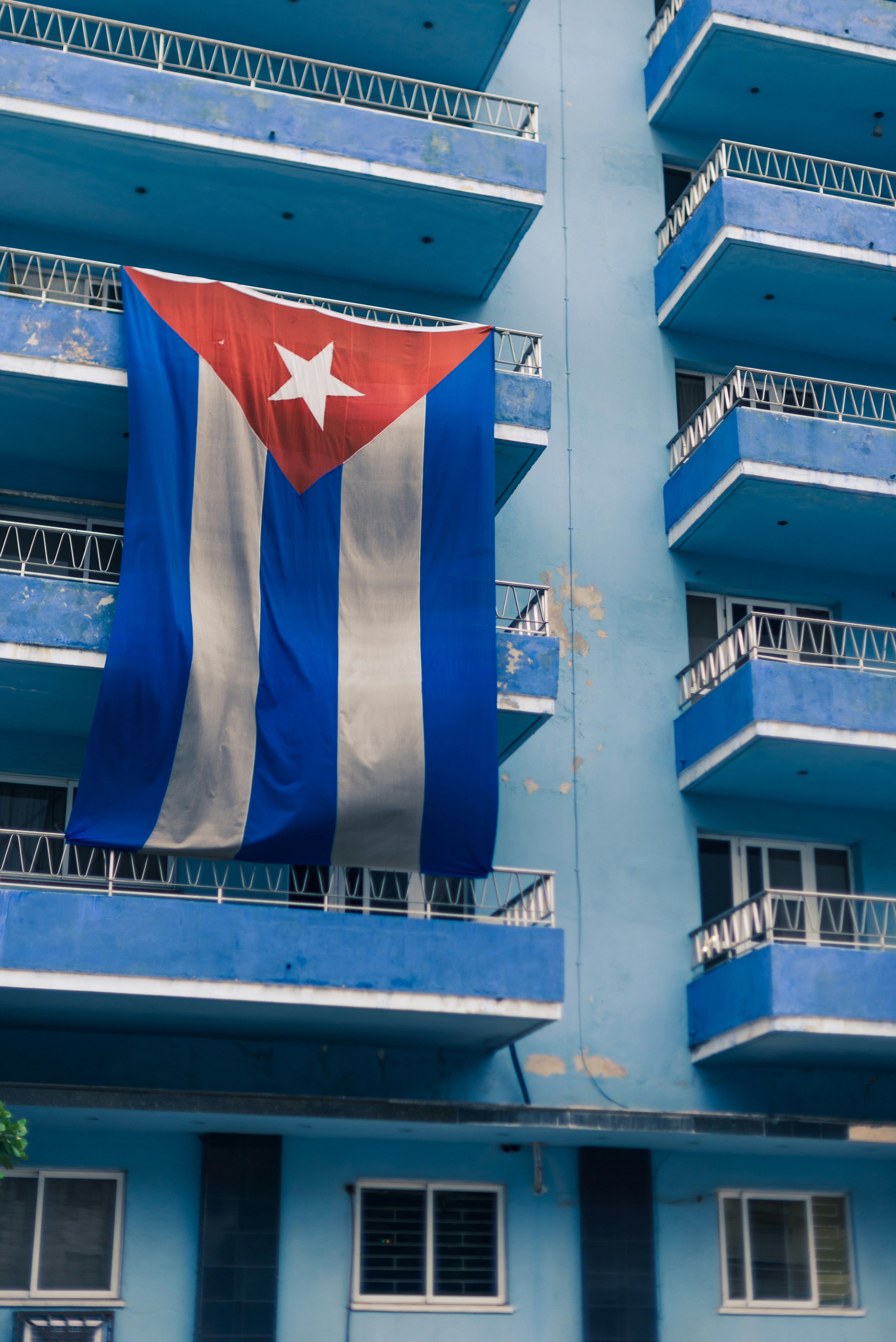 A large flag hanging from the side of a building