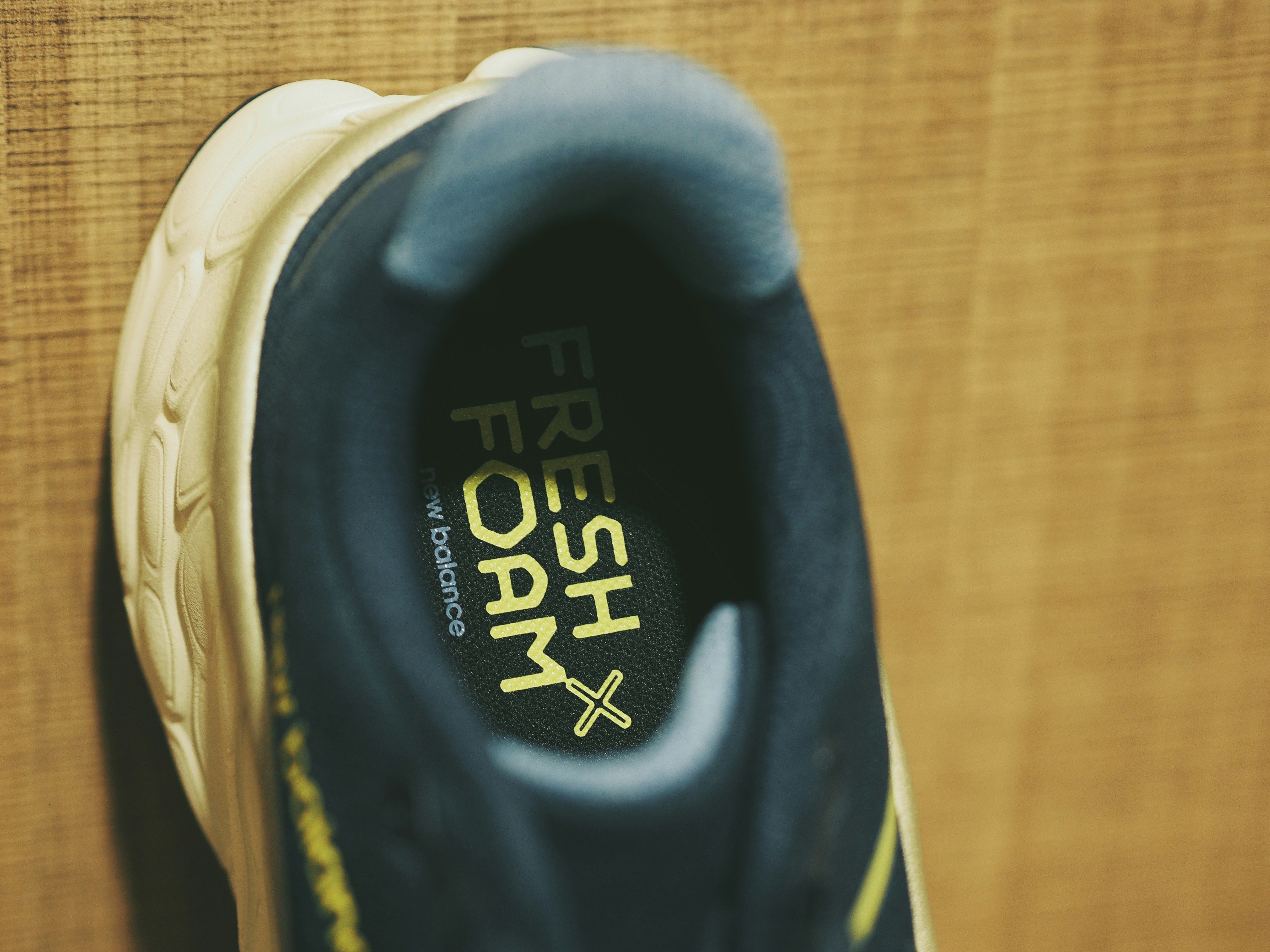 A pair of black and yellow shoes hanging on a wall