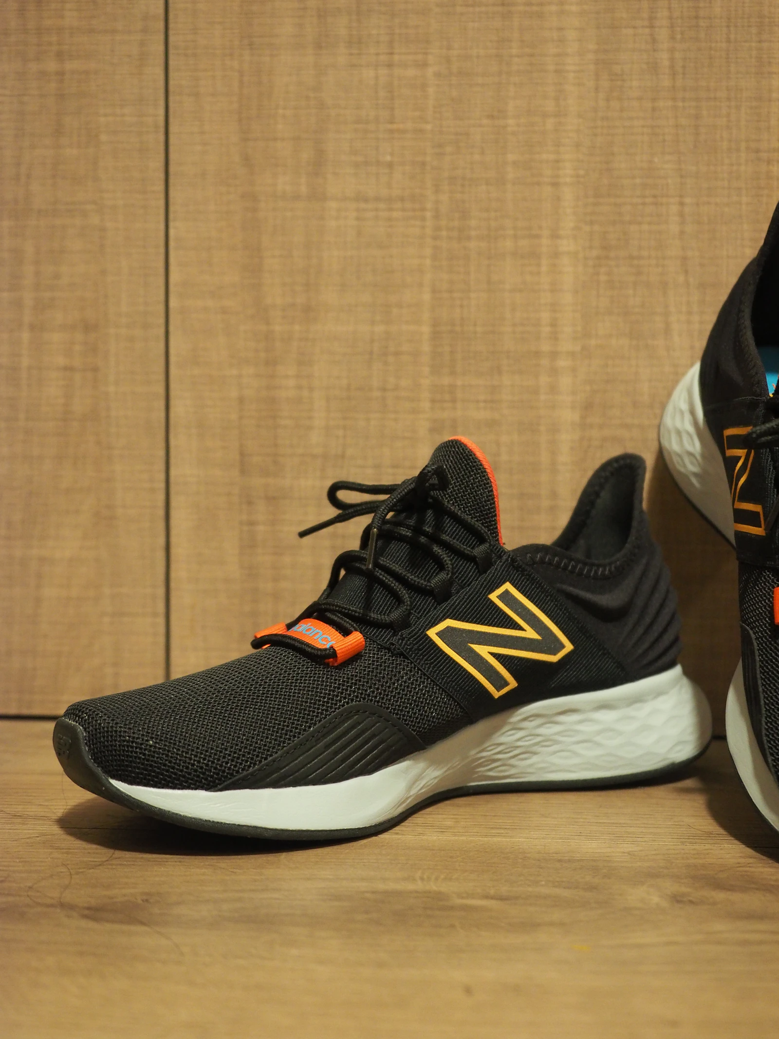 New Balance Fresh Foam black running shoes on wood